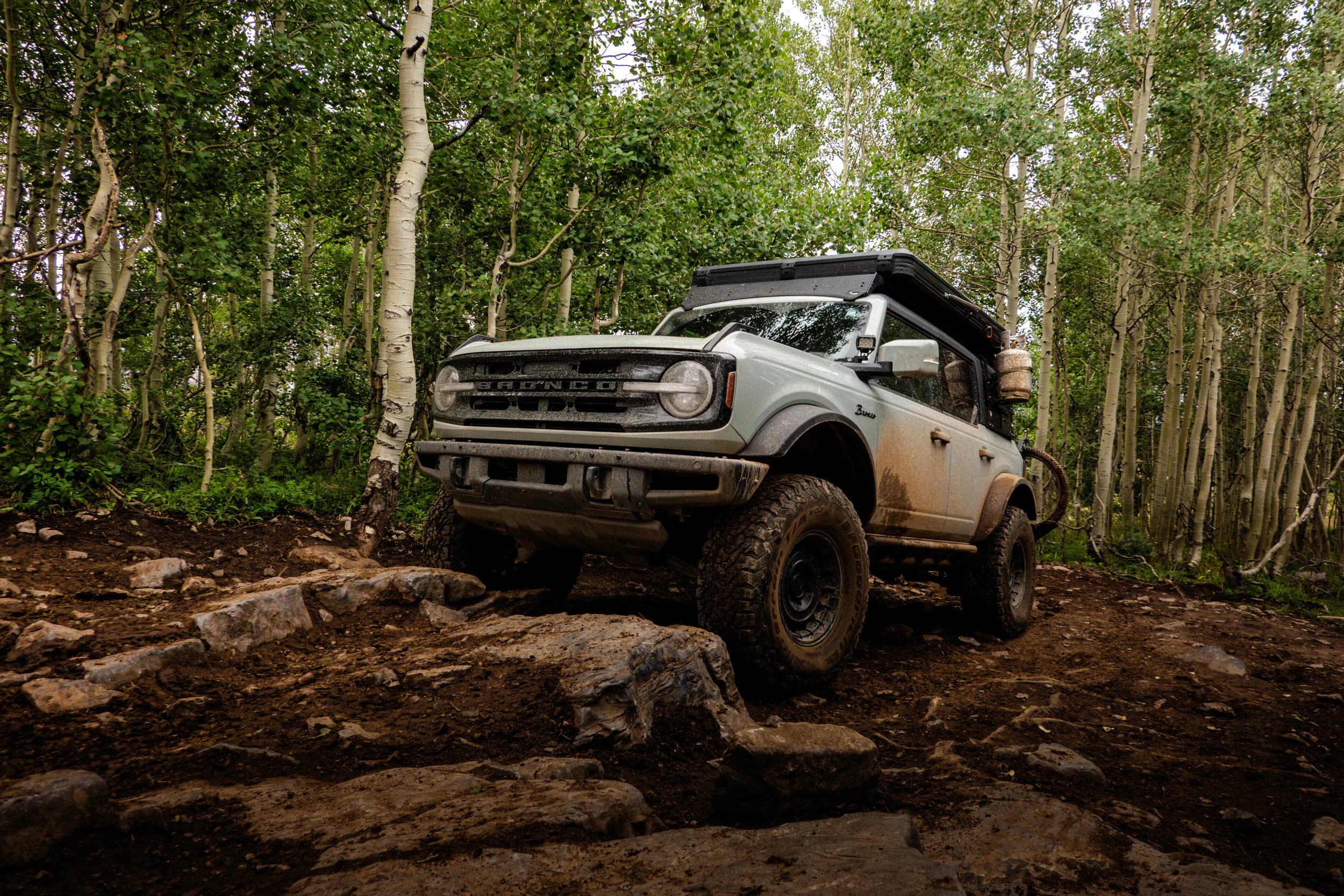 ford bronco climbing muddy rocks