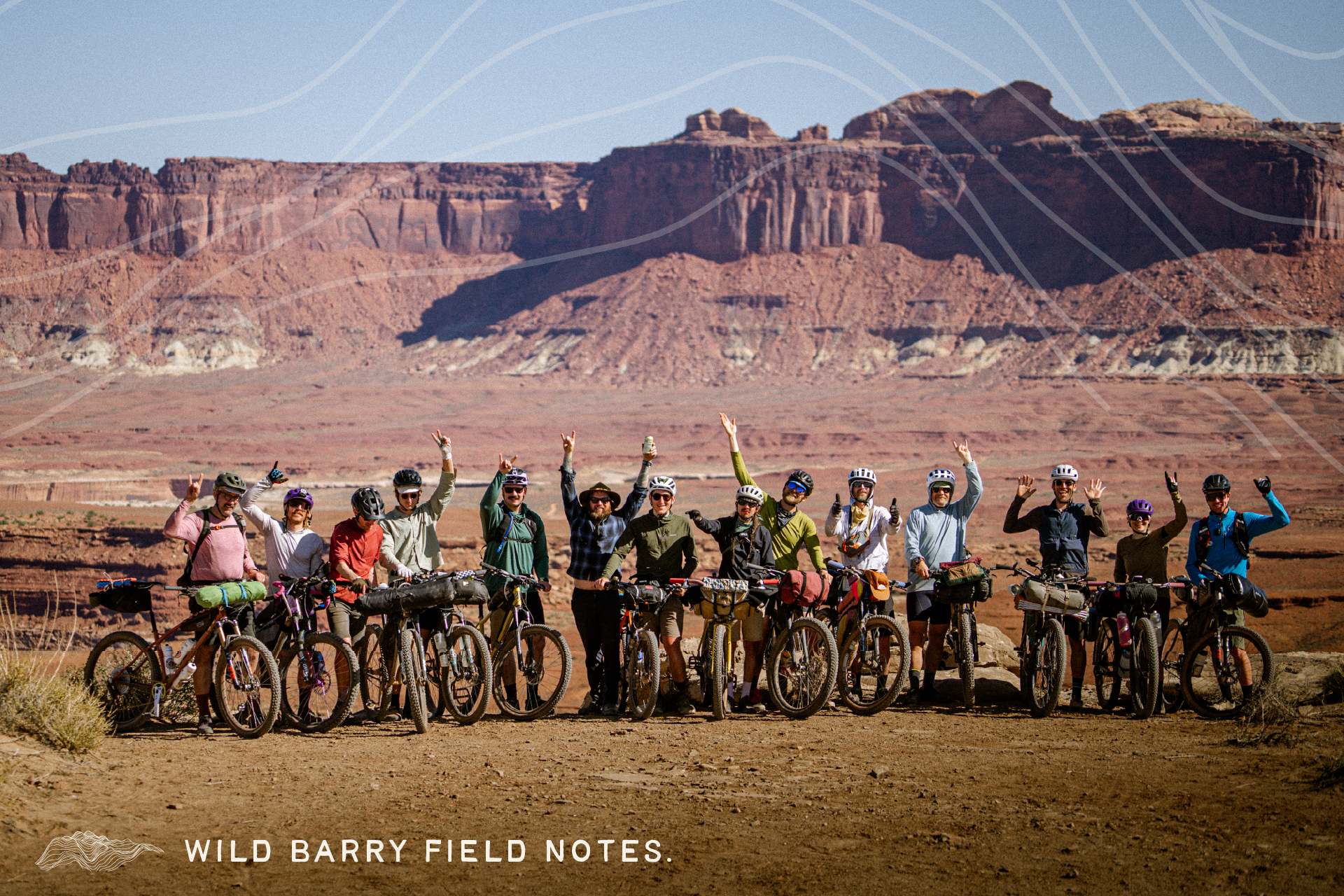 group of riders on a cliff with bikes