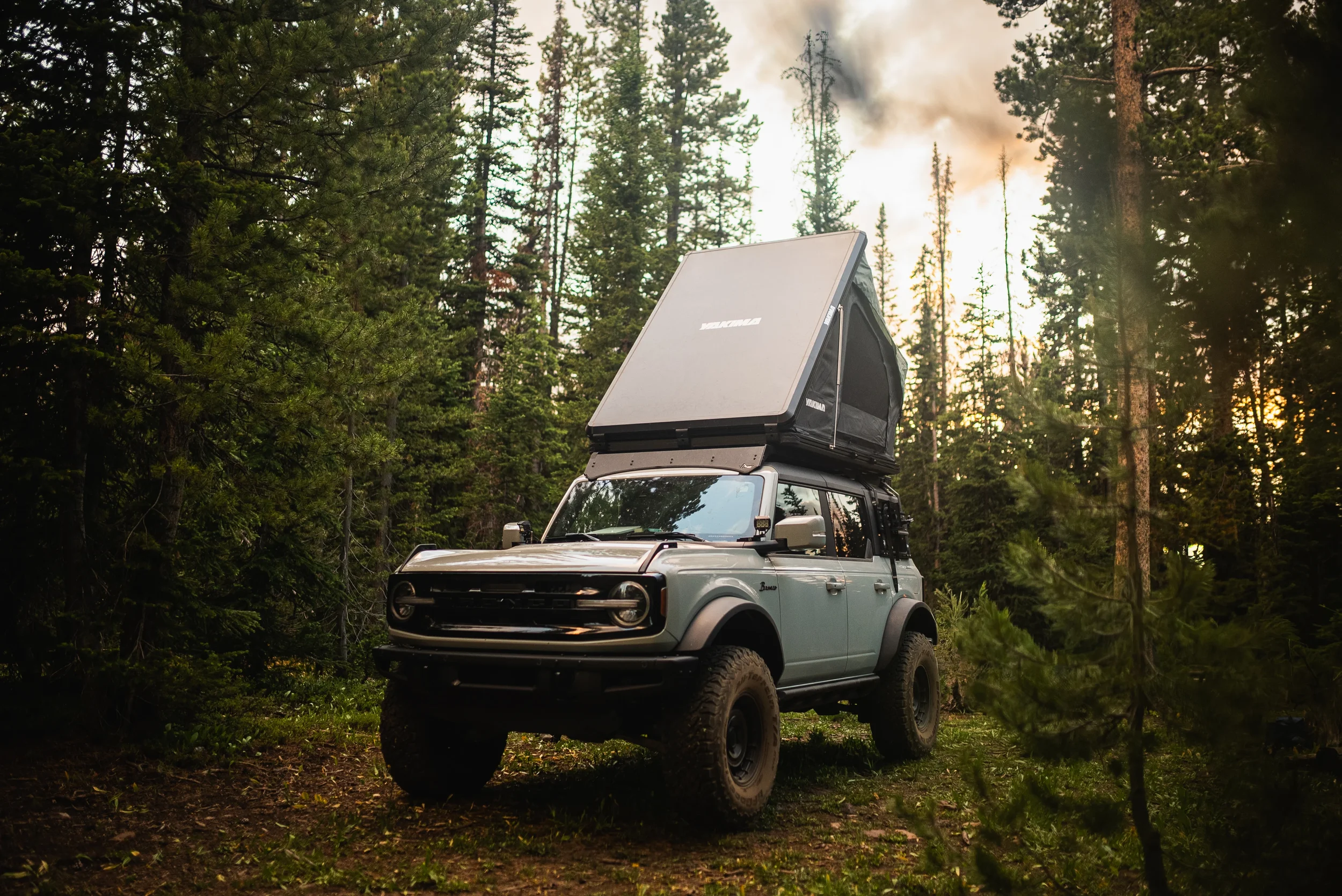 bronco and yakima rooftop tent in the forest