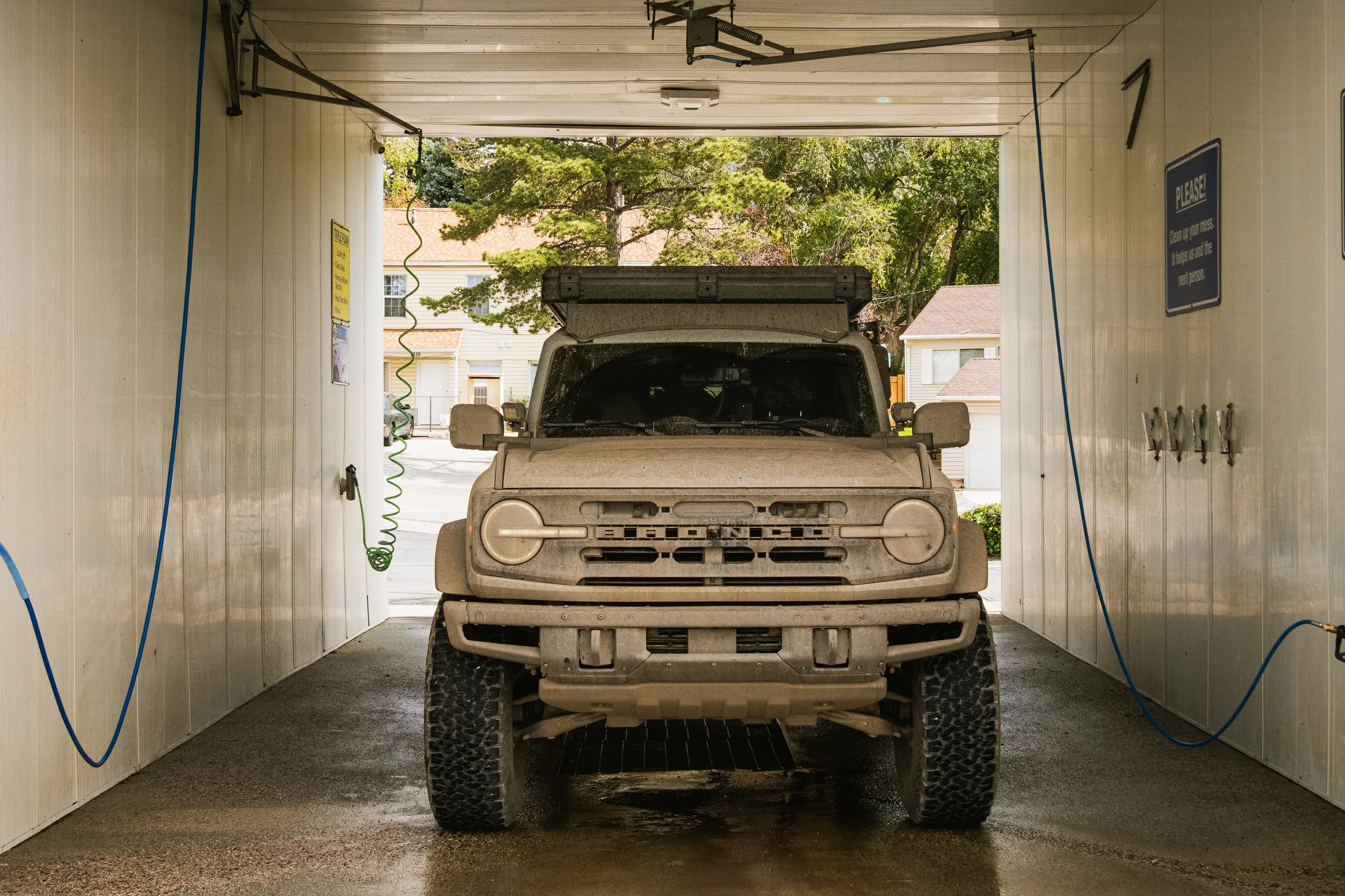 muddy bronco in a car wash bay