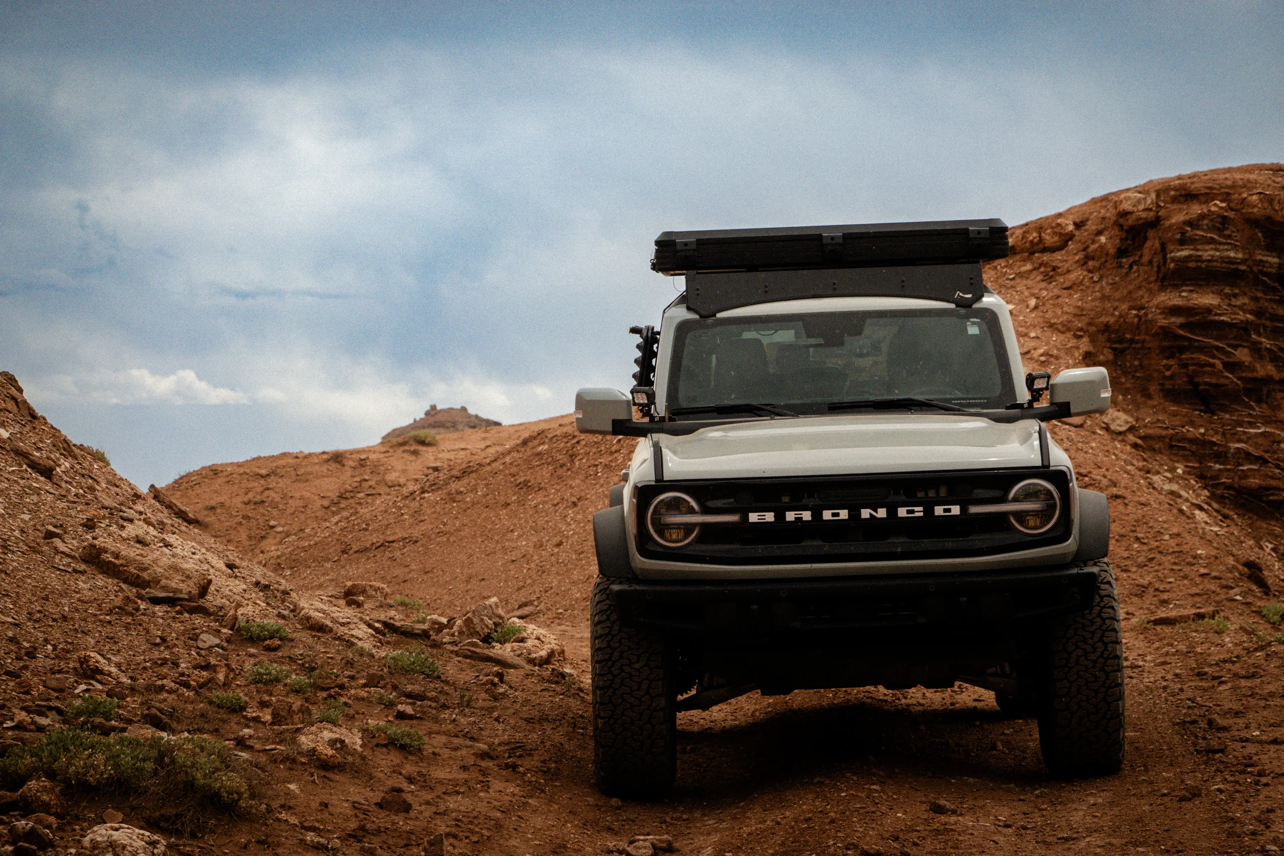 bronco on a dirt road in the desert