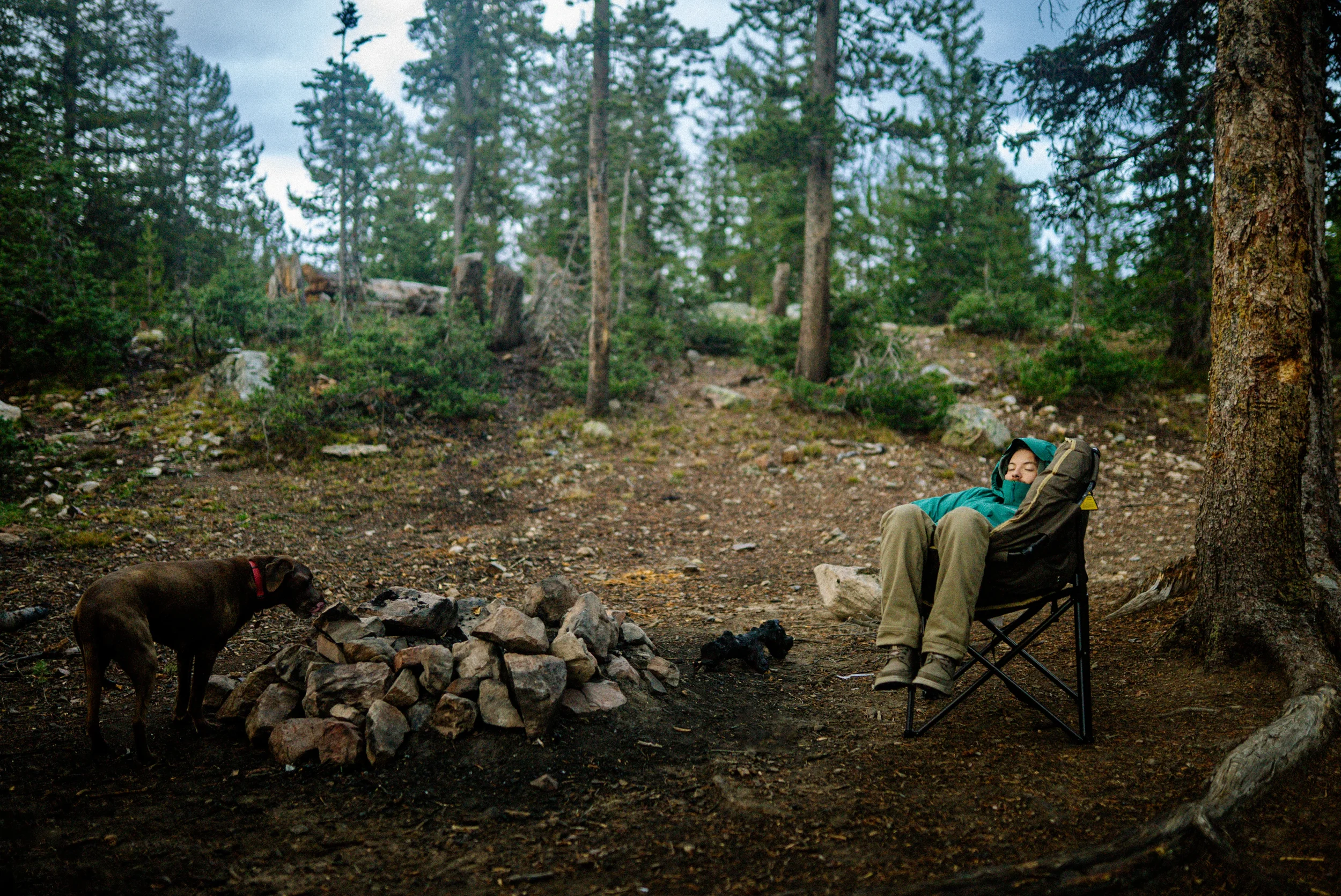 man sleeping in a camp chair