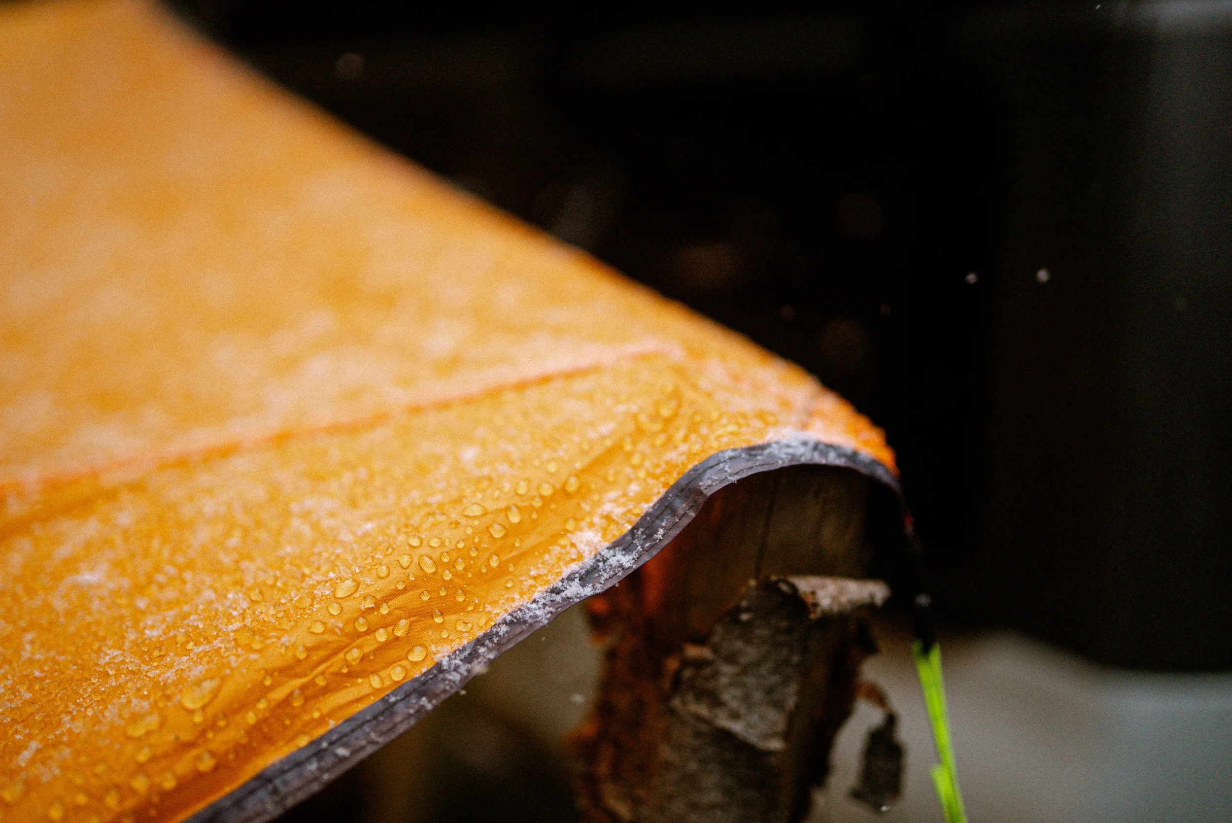 closeup of snowflakes on an orange tarp