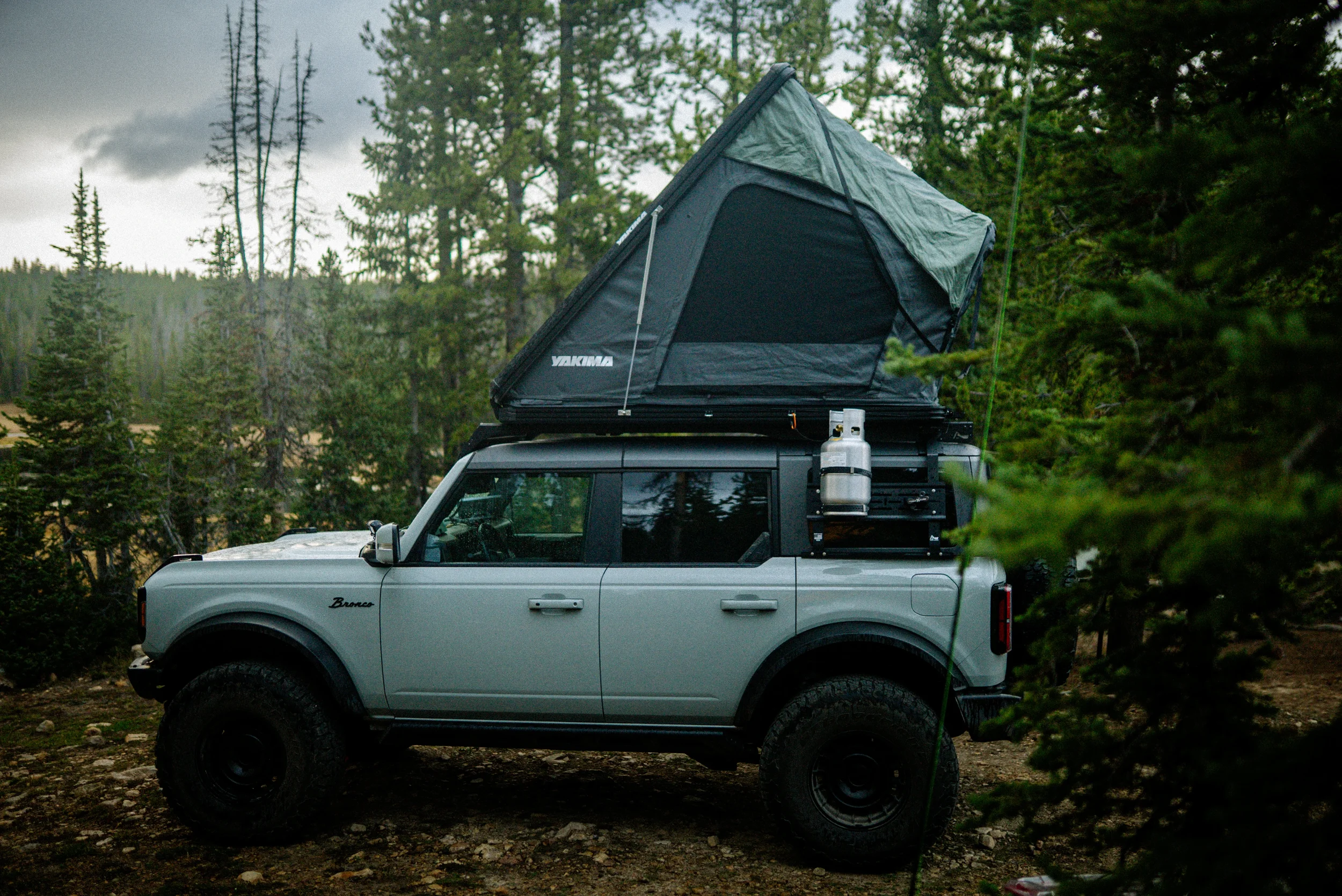 ford bronco with yakima rooftop tent camped near a lake