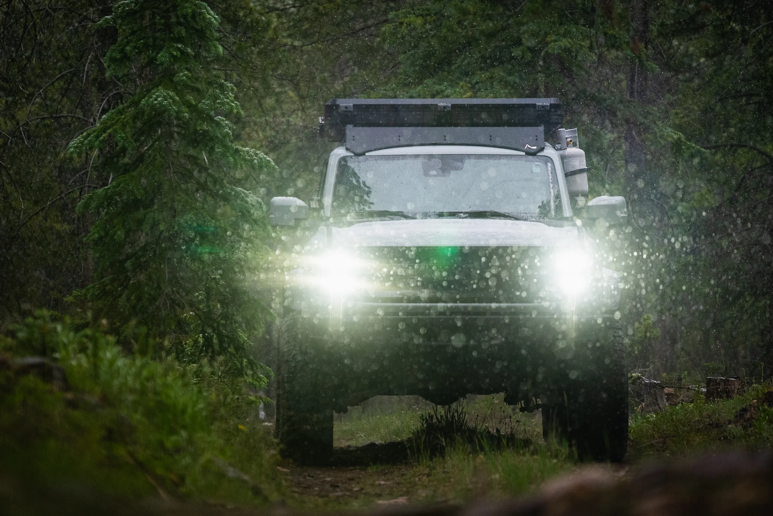 bronco driving down a snowy forest road