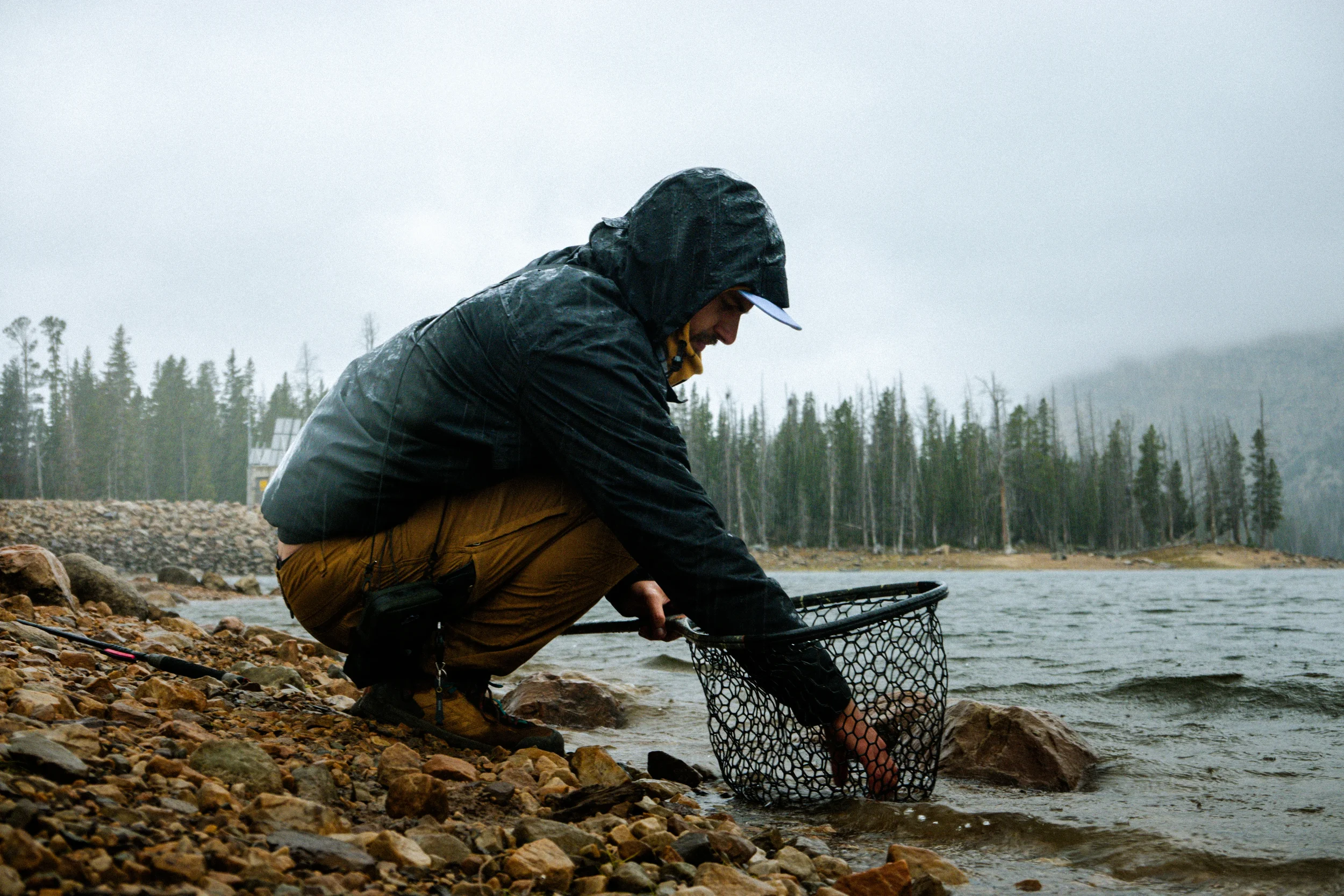 man holding a fish in a net