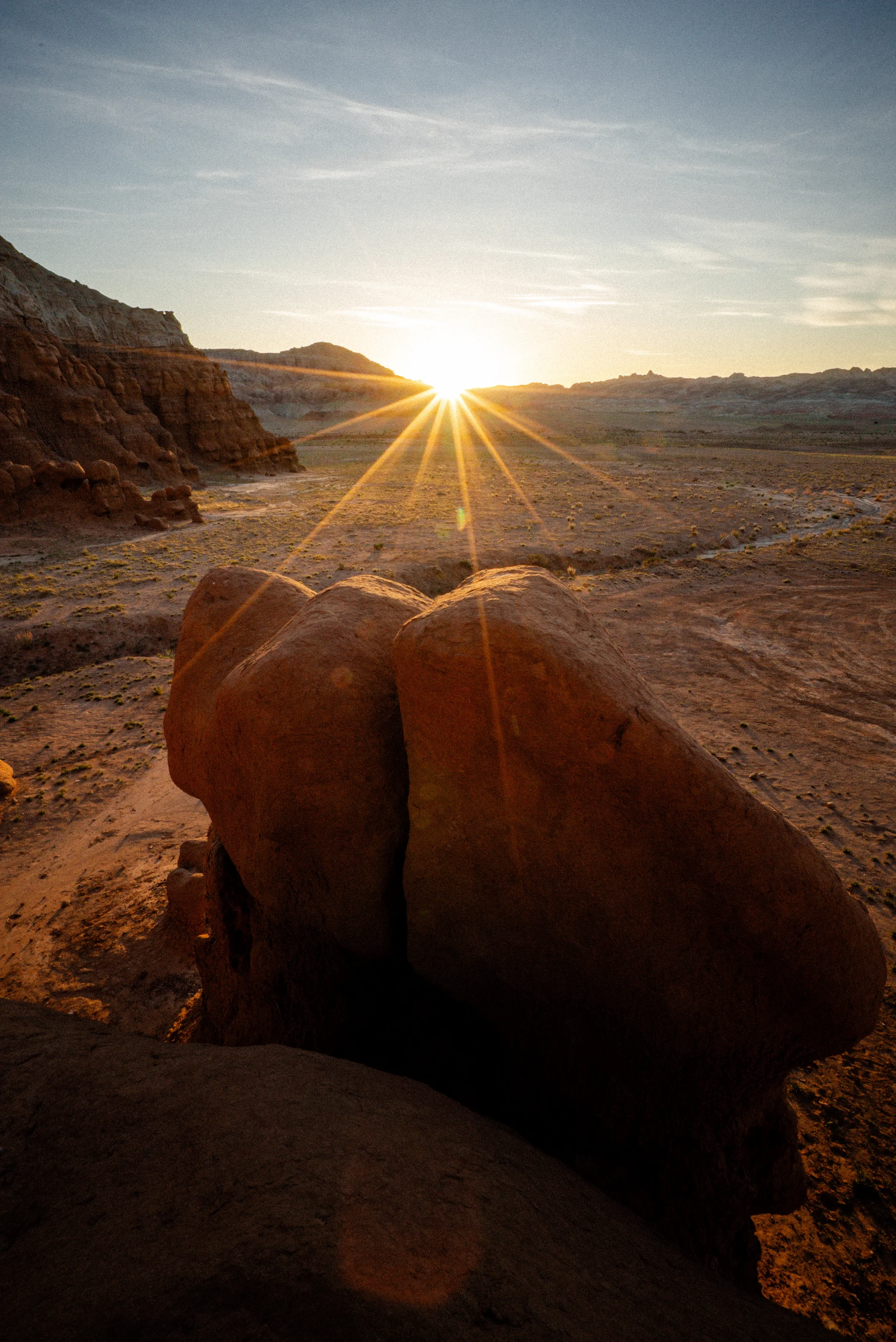 sunset and light rays over goblin valley