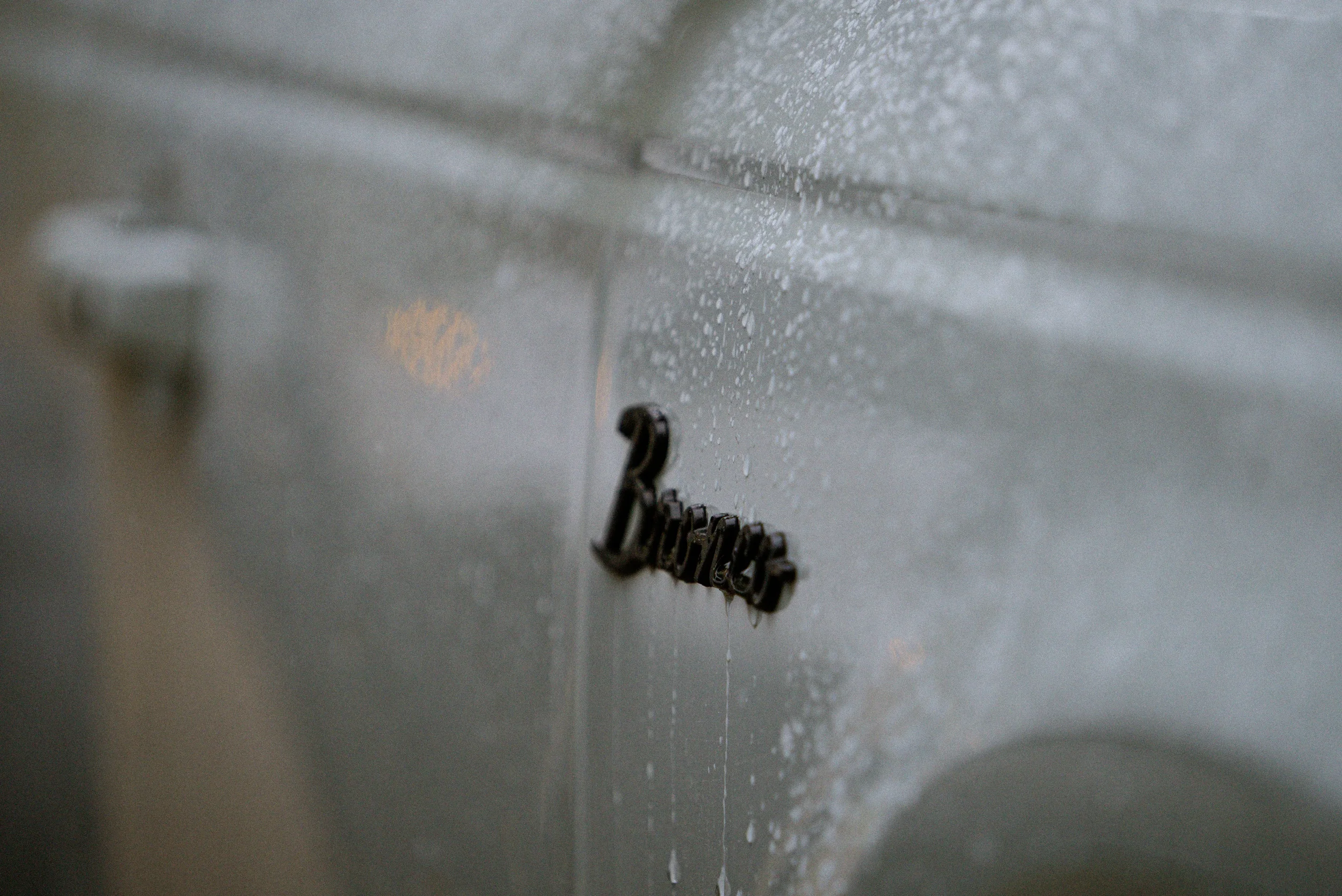 snow and rain running down a truck door