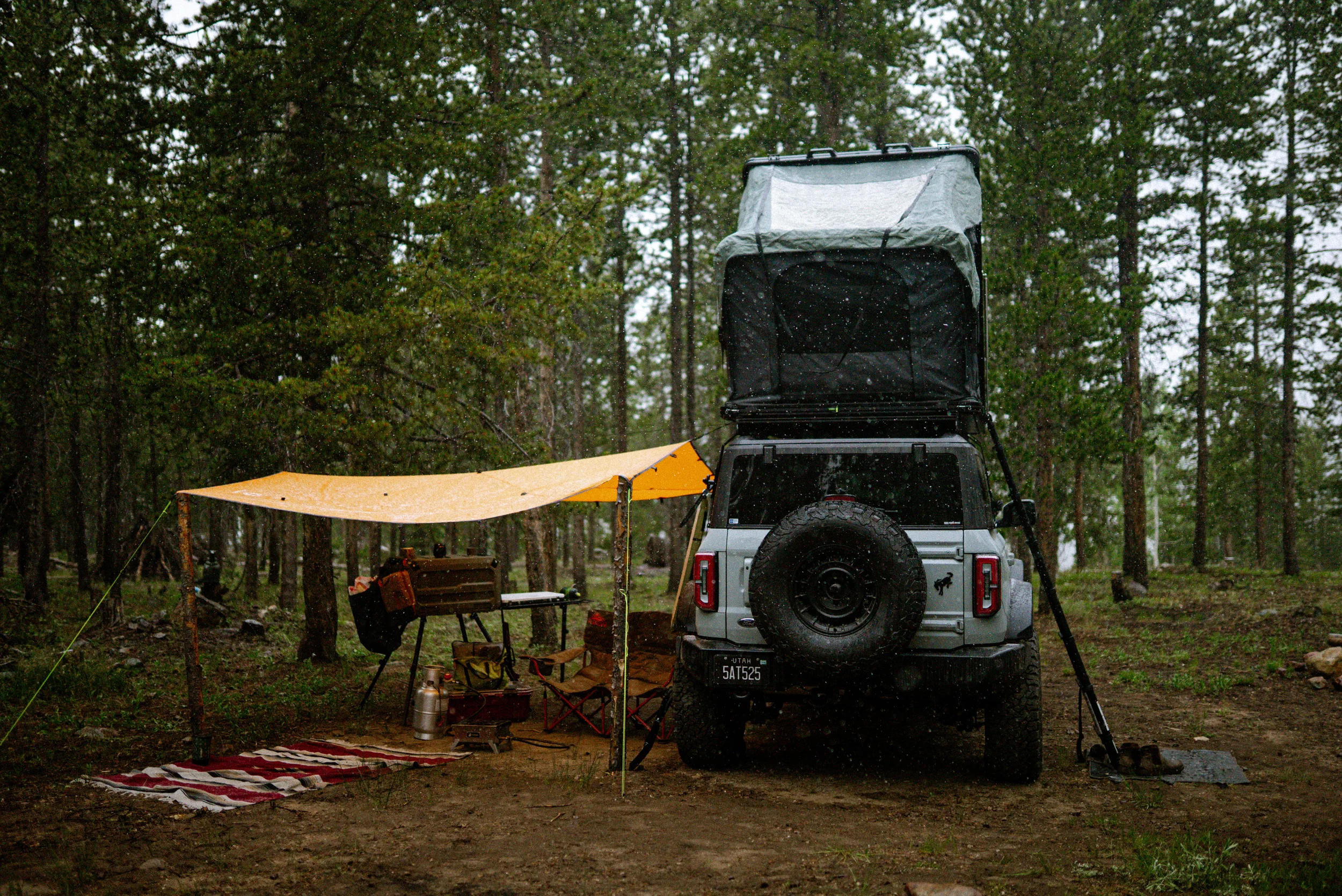 orange tarp setup in mountain snowstorm