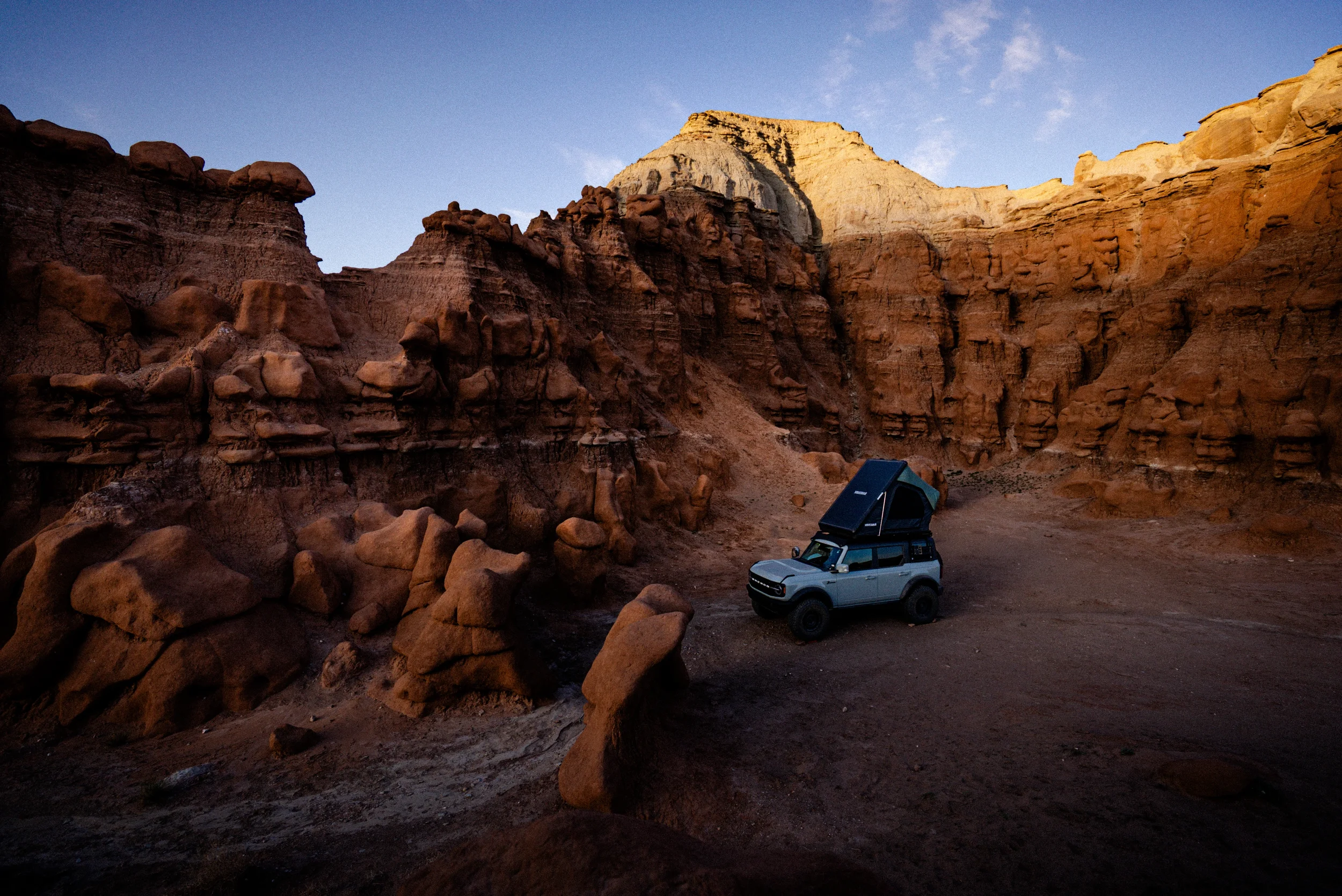 bronco with roof top tent camped in goblin valley hoodoos