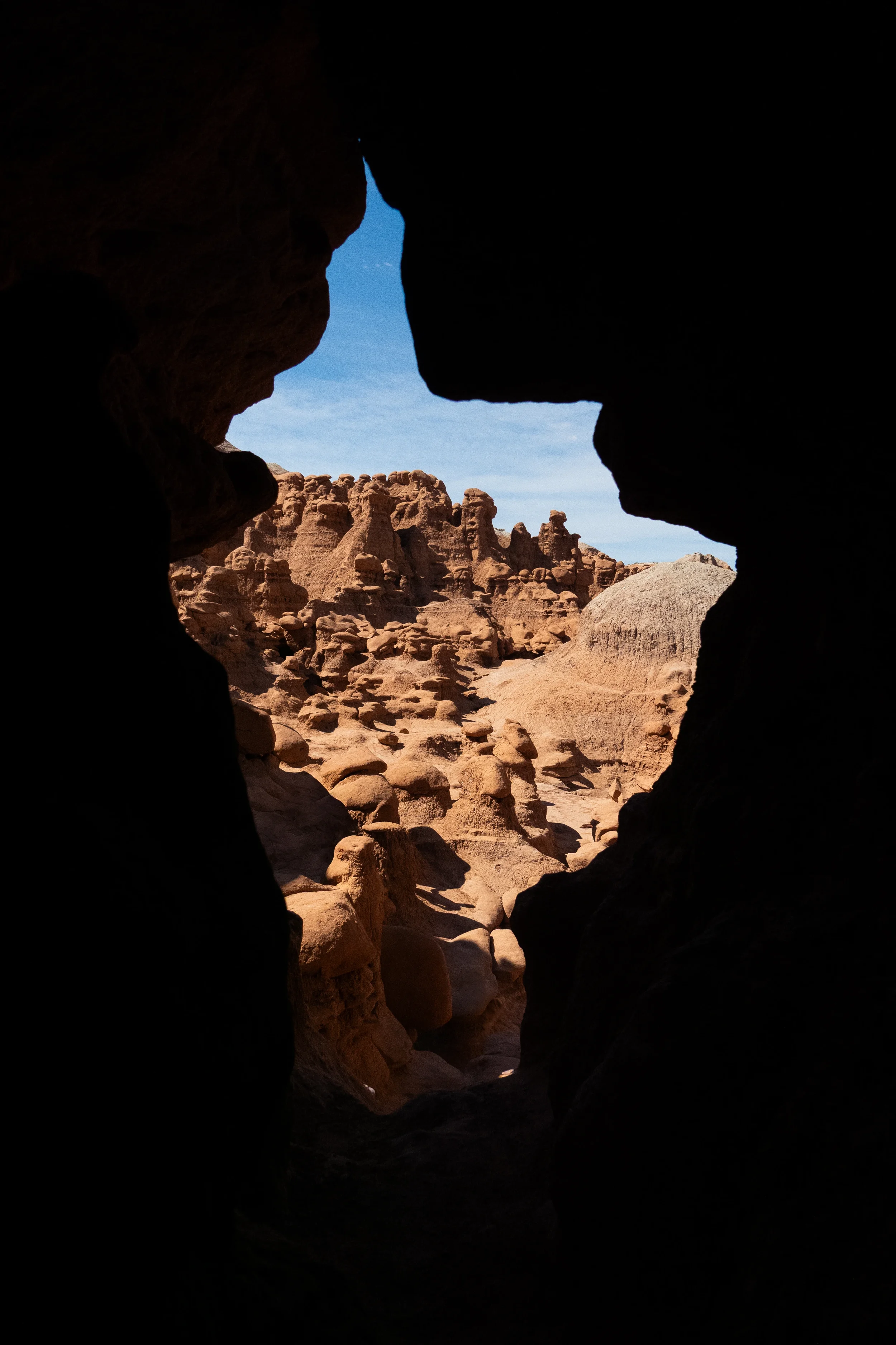 goblin valley framed by the opening of a cave