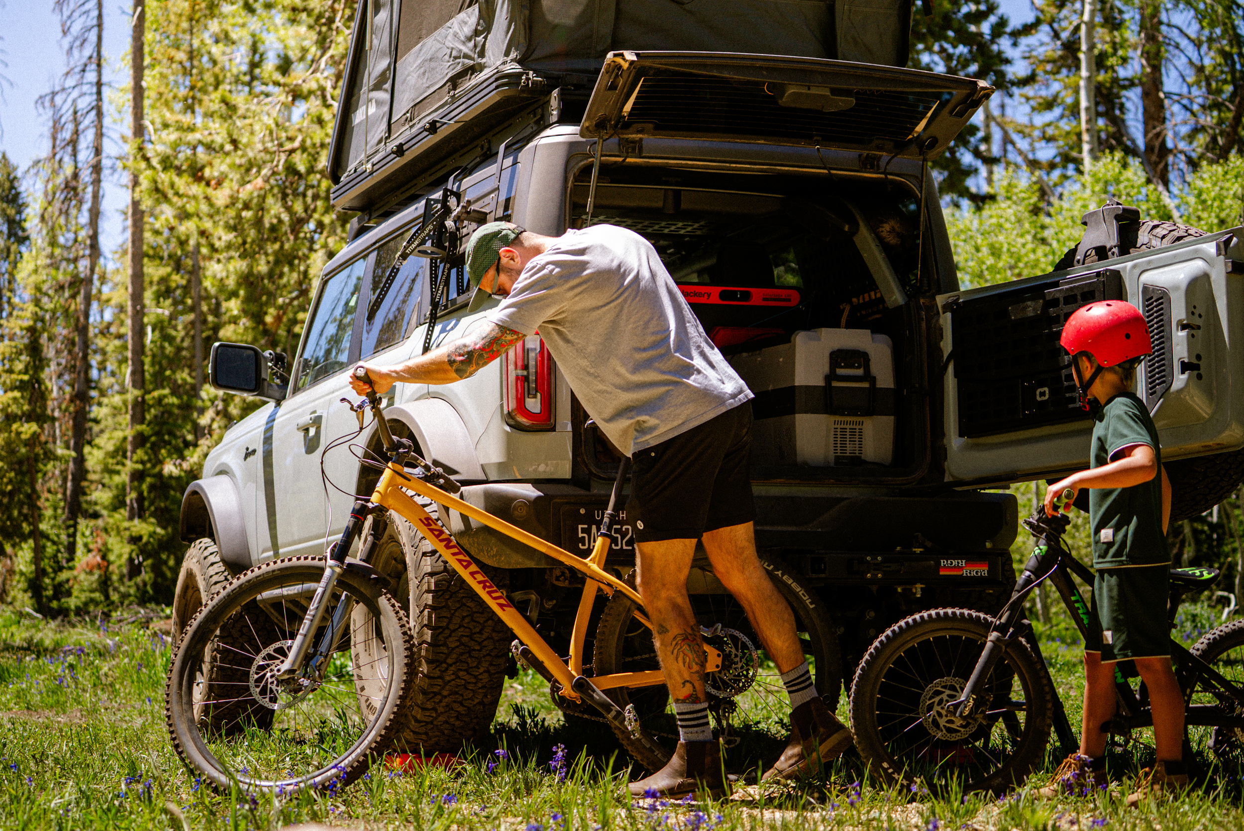 man and child gearing up mountain bikes