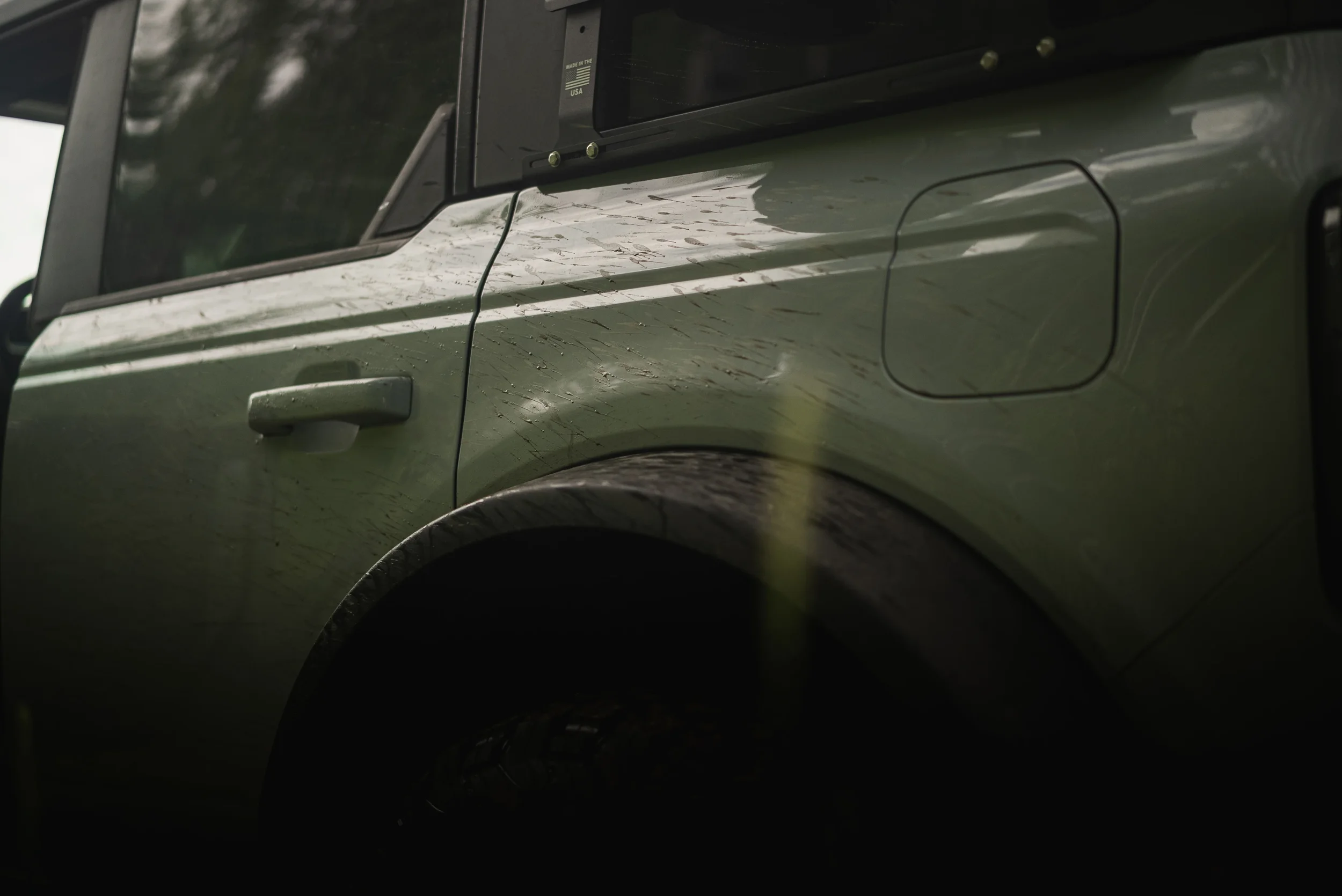 mud splatters on the side of a bronco