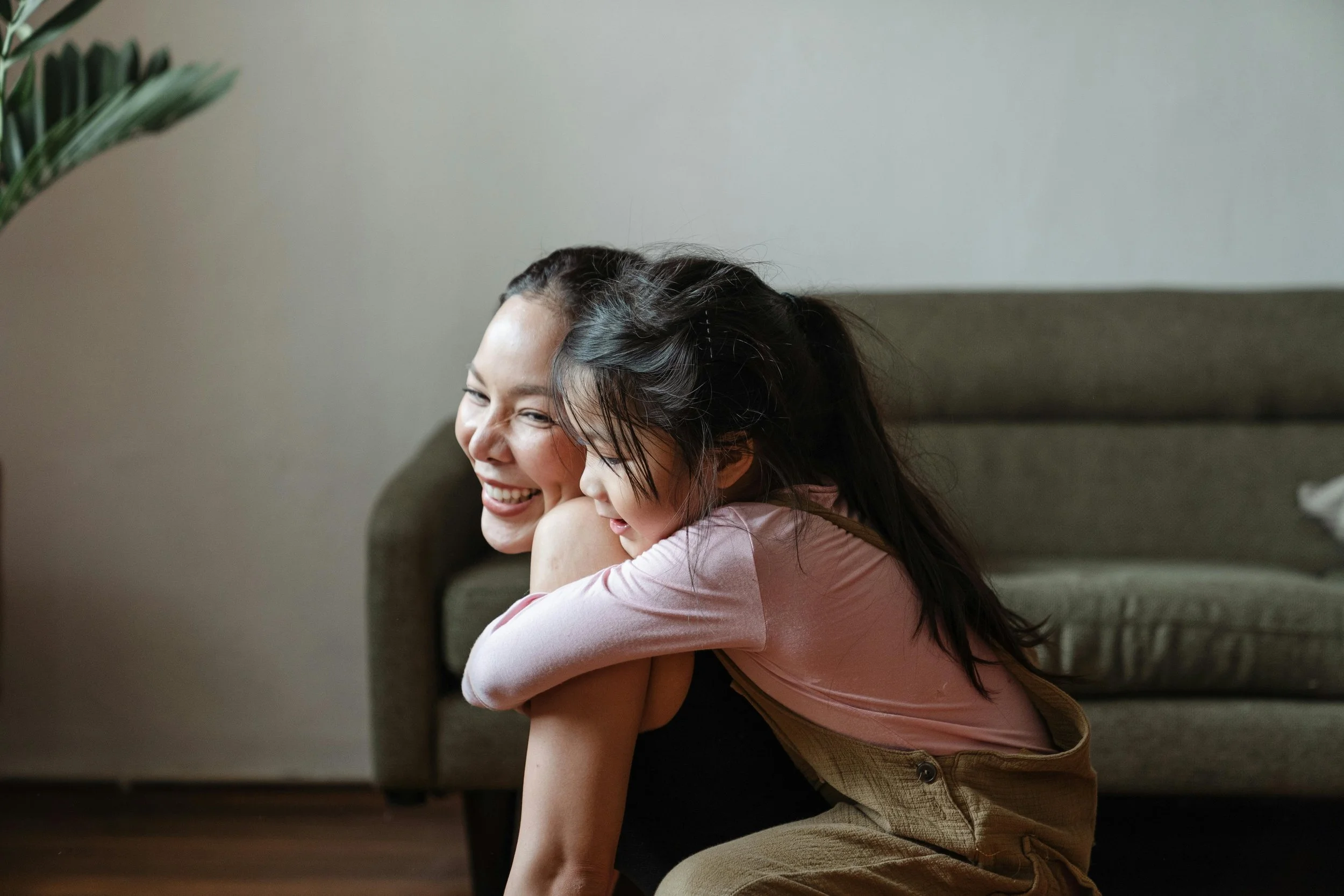 Mom and girl hugging eachother smiling