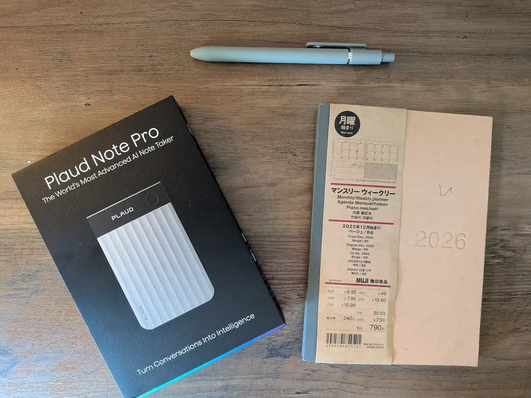 PLAUD Note Pro box on desk next to planner and pen