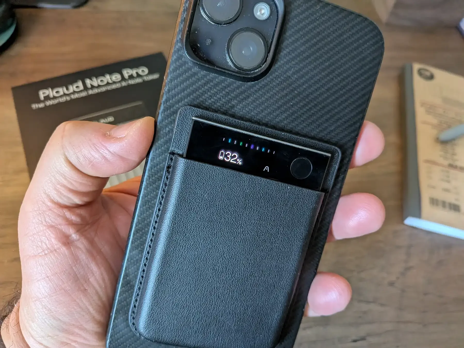 PLAUD Note Pro attached to iPhone case in leather magnetic sleeve