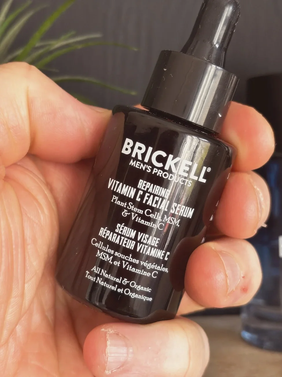Jerome from By Jerome holding Brickell Men's Repairing Vitamin C Facial Serum, reviewing anti-aging ingredients for men over 50.