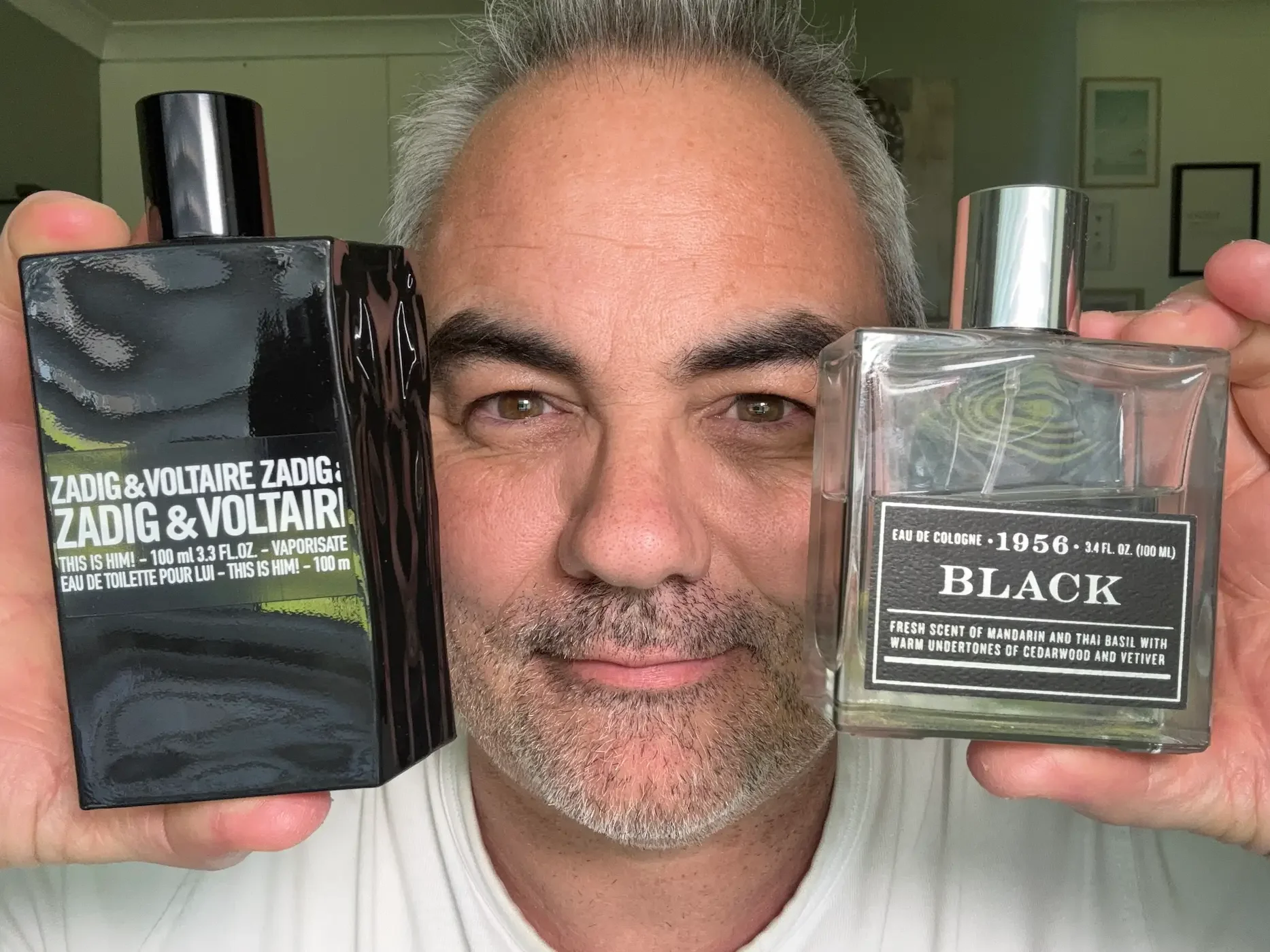 Jerome presenting a side-by-side comparison of Zadig & Voltaire 'This is Him' Eau de Toilette and 1956 Black Eau de Cologne to explain fragrance strengths.