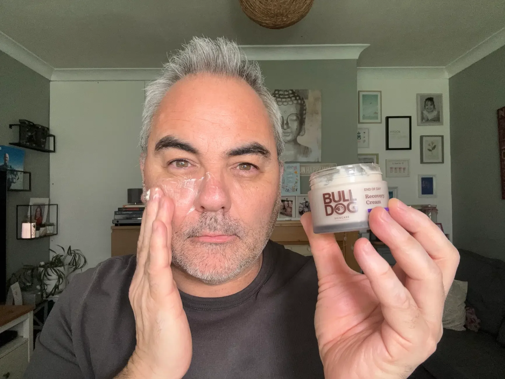 Jerome applying Bulldog End of Day Recovery Night Cream to his face to test the texture and hydration for mature skin.