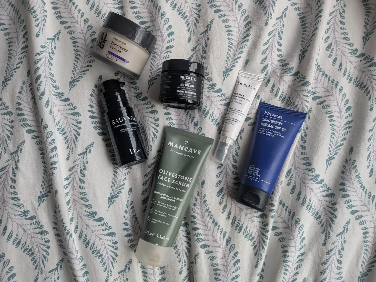 A flat-lay selection of men's skincare products including Dior, Bulldog, Brickell, Horace, and Blu Atlas, tested by Jerome.
