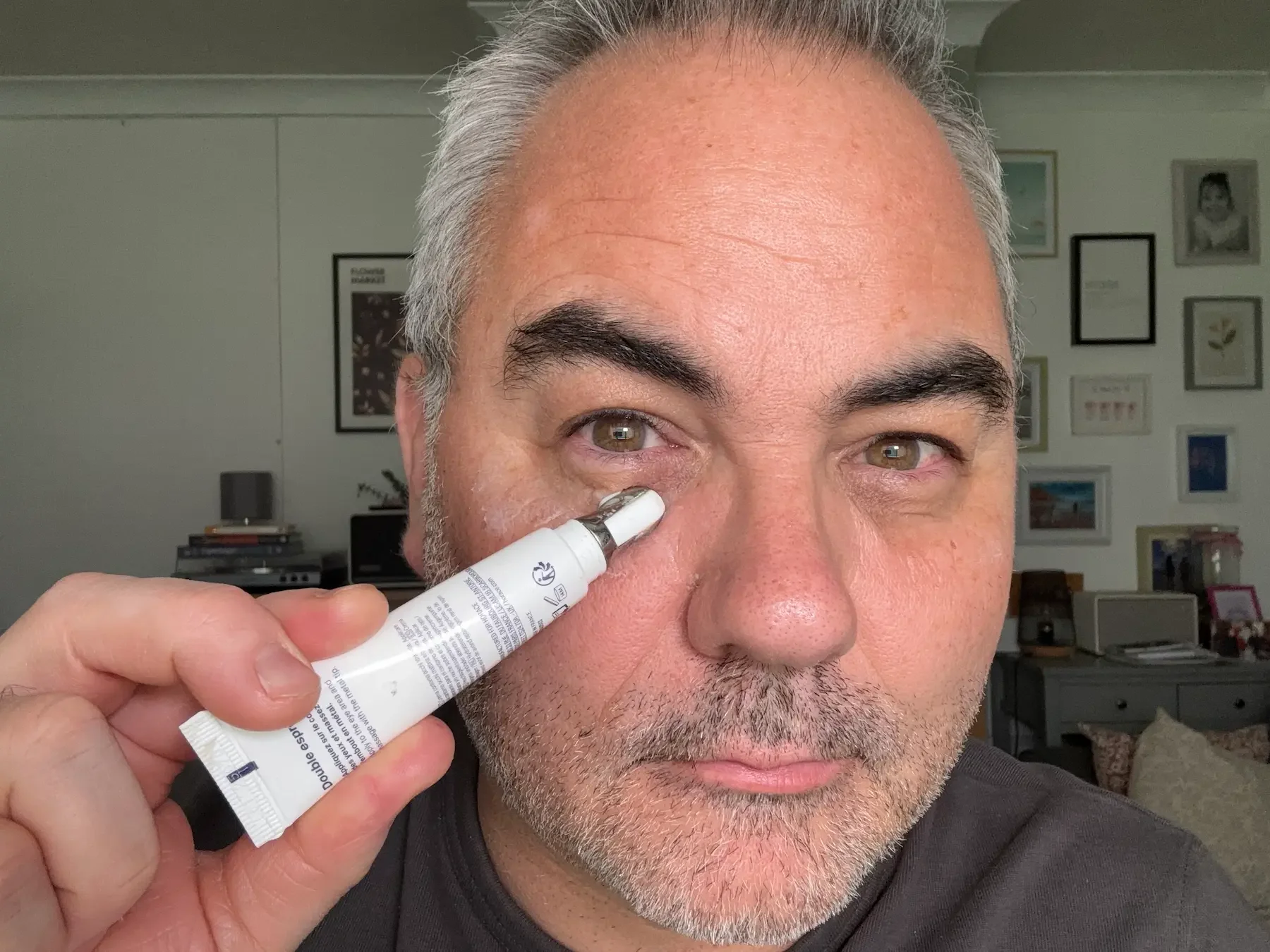 Jerome using the metal applicator of the Horace 8h Sleep Eye Contour to reduce puffiness and hydrate the under-eye area.