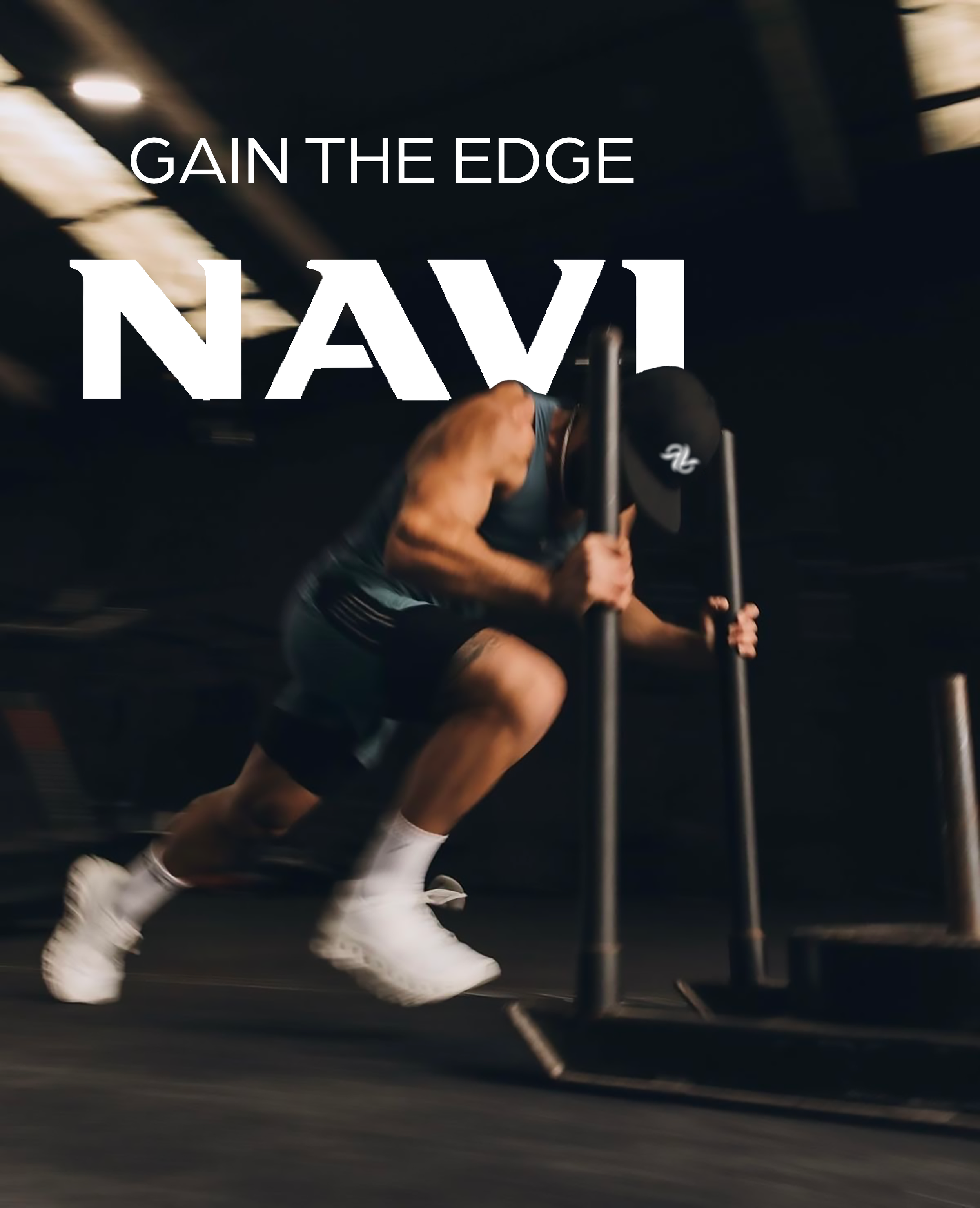 A man pushing a weighted sled on a dark gym floor, with the text 'Gain the Edge Navy' overlaid.