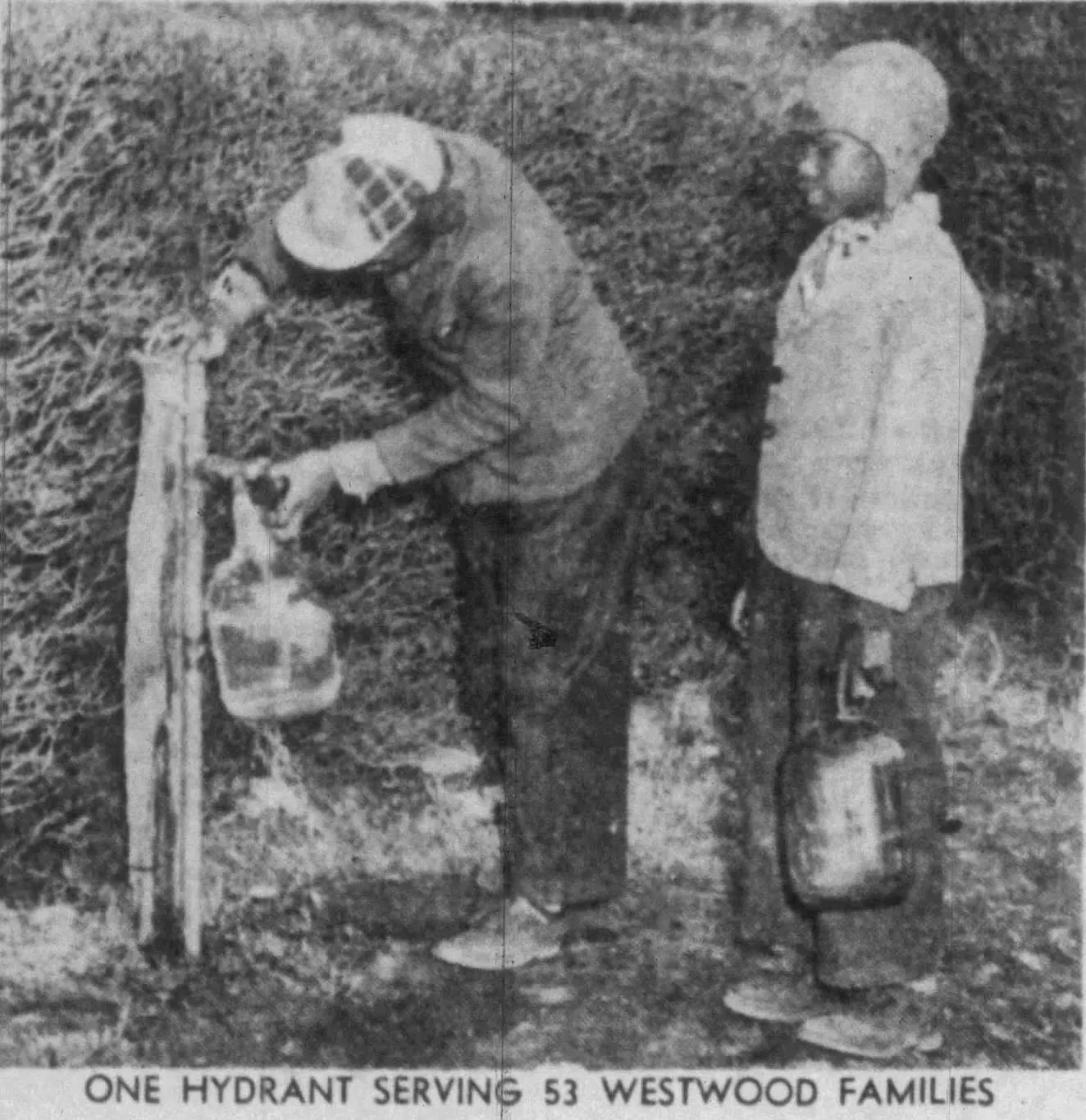 A black and white photo shows a man filling a large container with water from a fire hydrant, with a woman standing nearby. The scene appears to be outdoors in a grassy area. The caption reads 'ONE HYDRANT SERVING 53 WESTWOOD FAMILIES.'