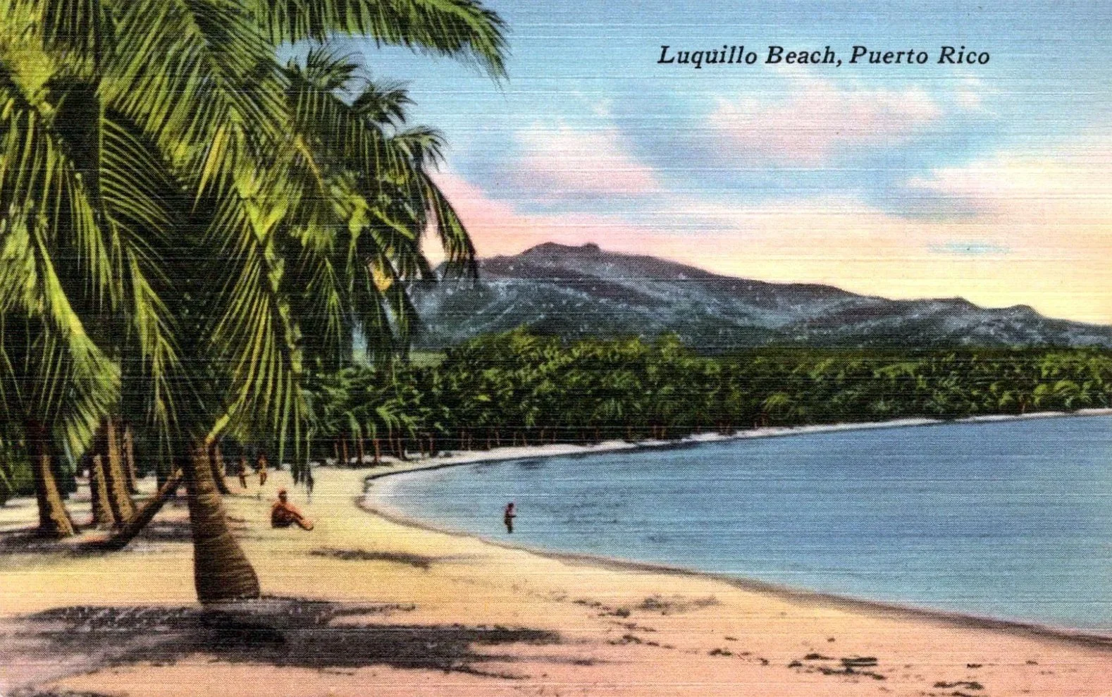 From a vintage postcard. Painting of Luquillo Beach in Puerto Rico showing palm trees, sandy shore, a person in the water, and mountains in the background with a pastel sky.