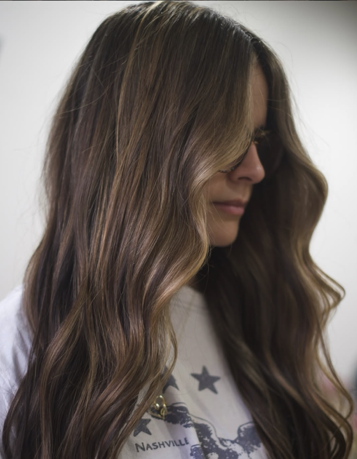 dimensional brunette hair with soft highlights in exton pa salon