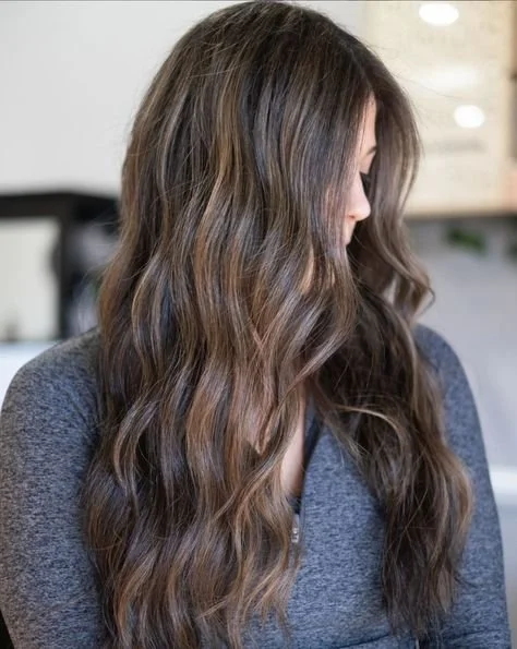 long dimensional brunette hair with soft waves in exton pa salon