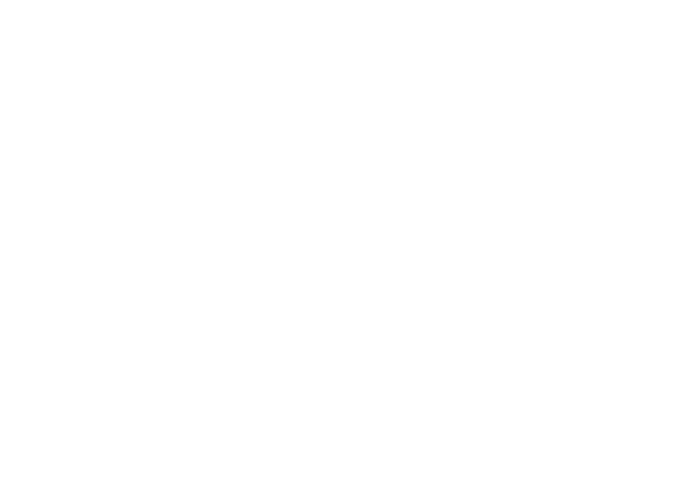Silhouette of a golf flagstick on a putting green.