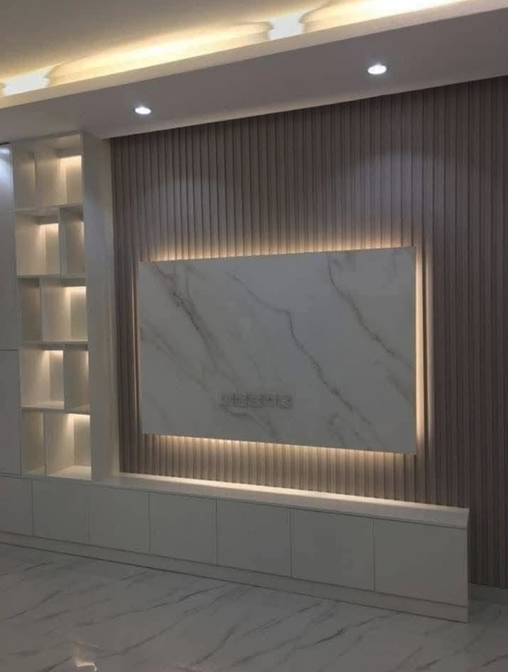 Modern interior wall with marble panel, wood paneling, built-in shelves, and recessed lighting.
