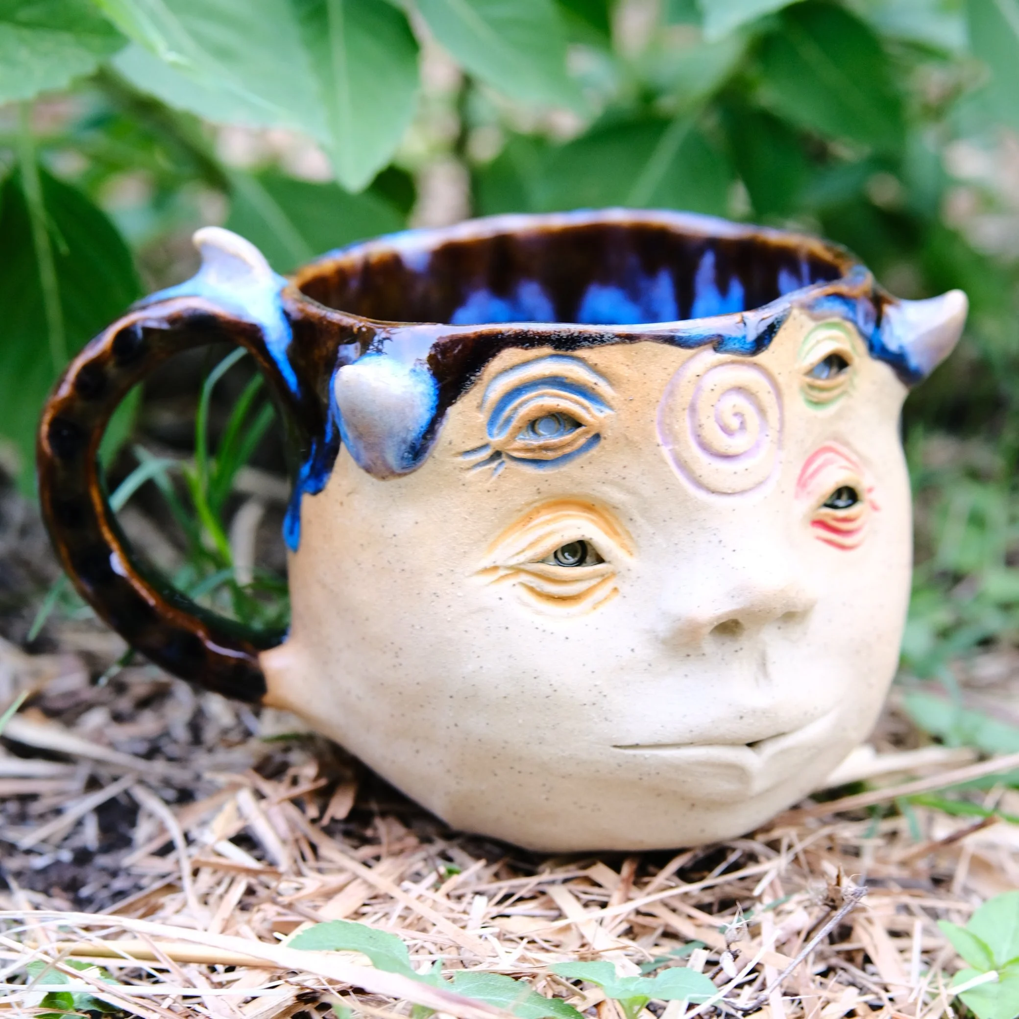 handmade ceramic mug with multiple eyes face whimsical fantasy pottery australia