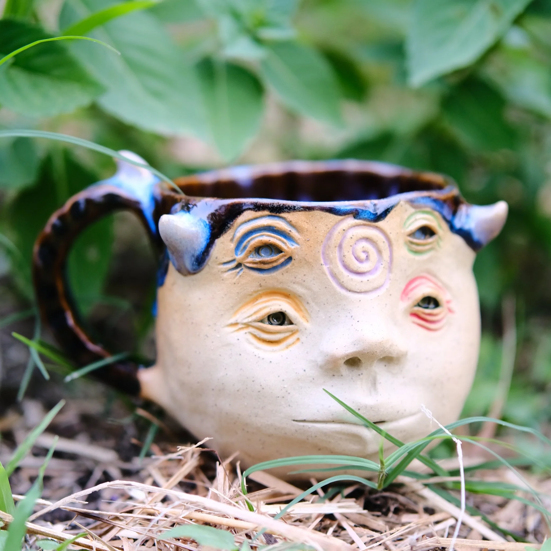 fantasy inspired pottery mug with detailed face design handmade in australia