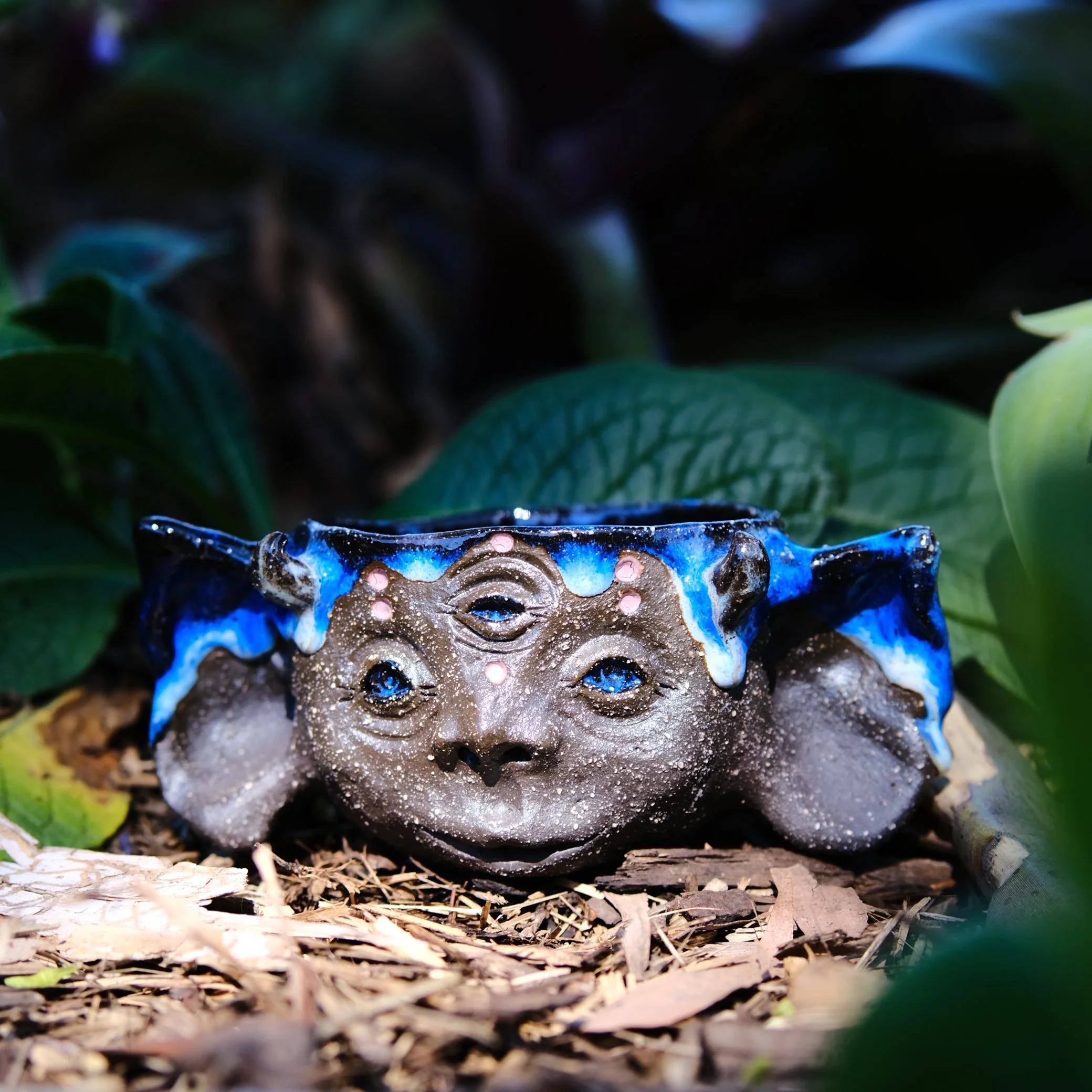 handmade ceramic elf cup with black clay and blue glaze australian pottery
