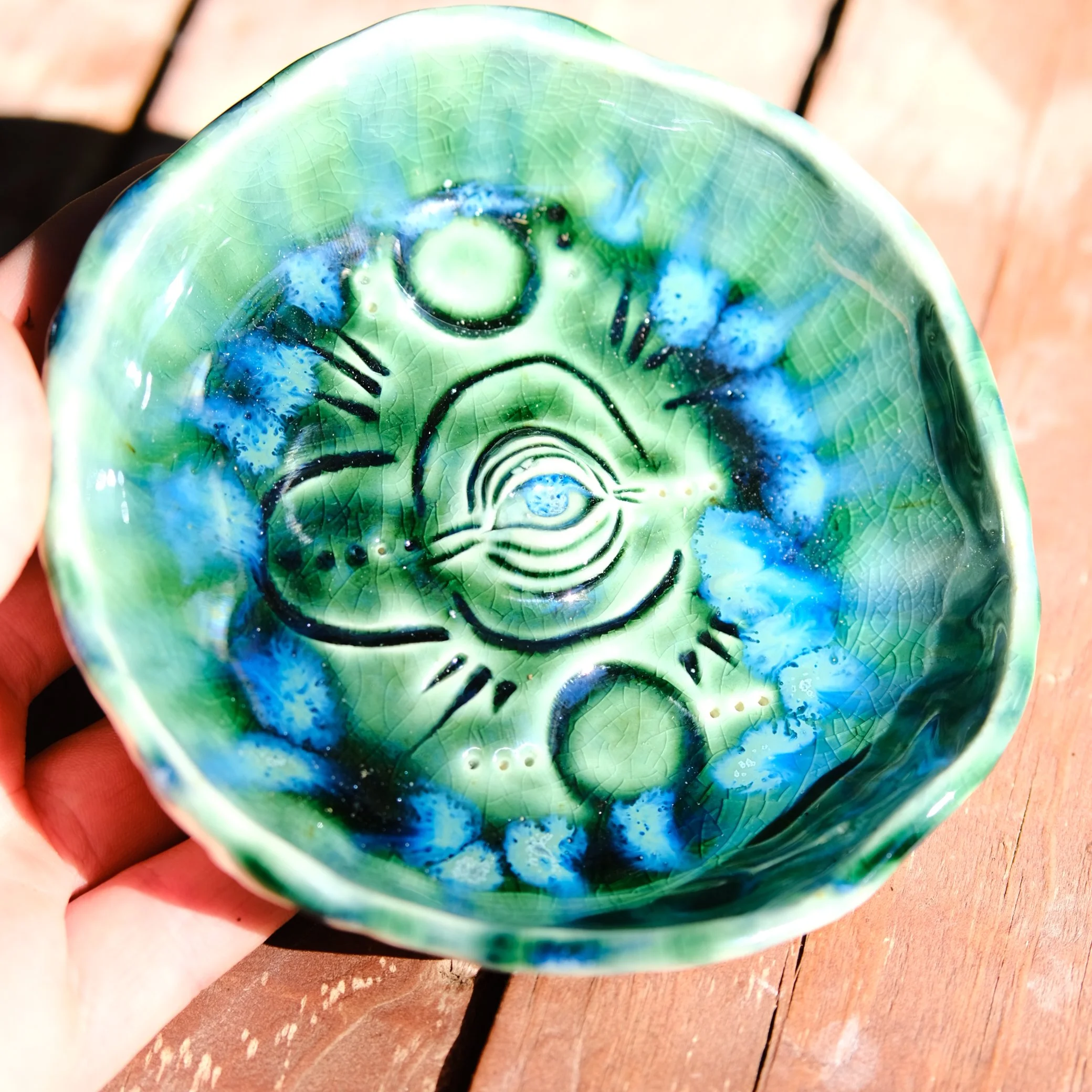 The Creator Eye trinket dish shown on a wooden surface, highlighting its size as a decorative or ritual tray.