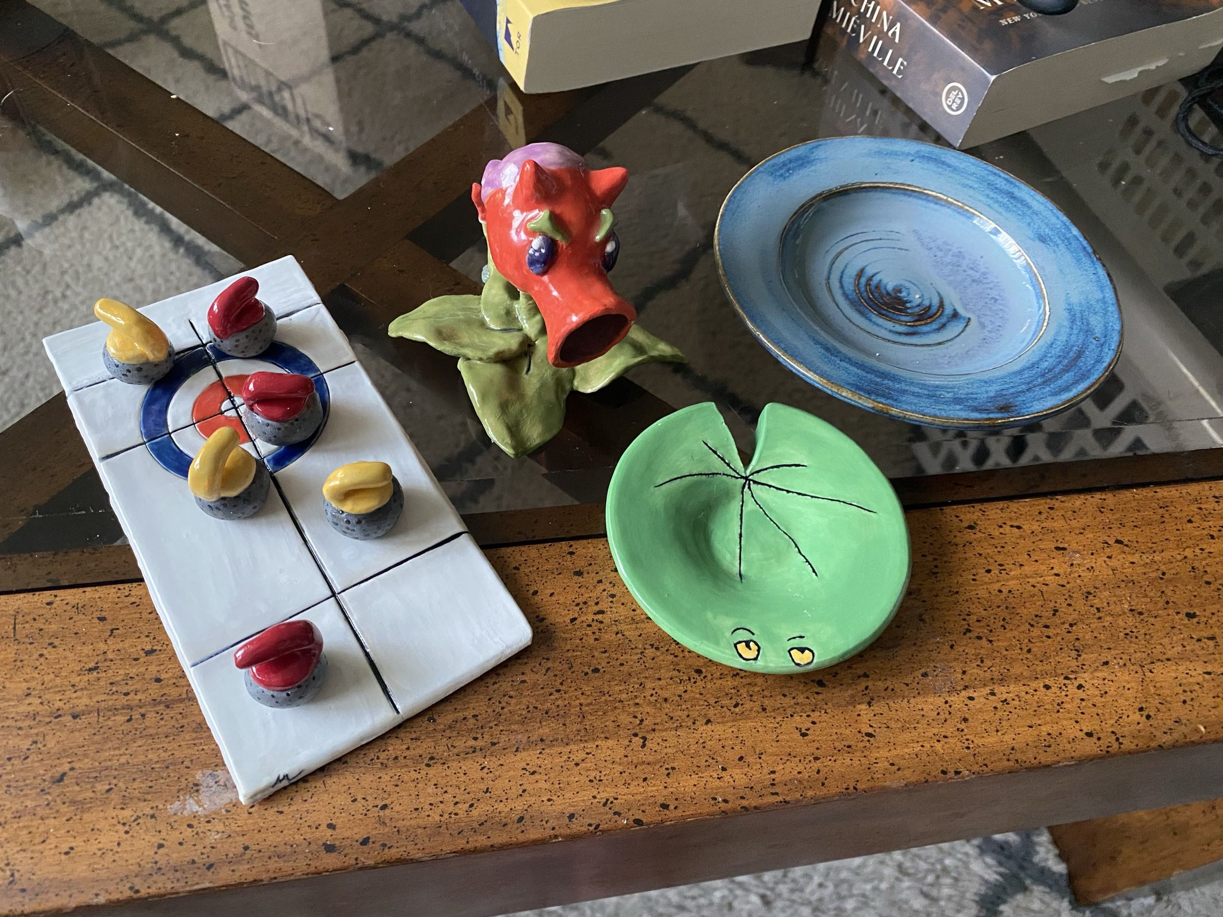 Some other pieces I fired around the same time as well, including a miniature curling set I gifted to my dad, a traditionally-glazed plate and a saucer glazed and carved to look like a lily pad from Plants vs Zombies.