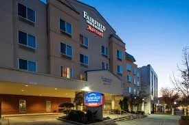 Fairfield Inn hotel exterior at dusk with lit entrance and sign