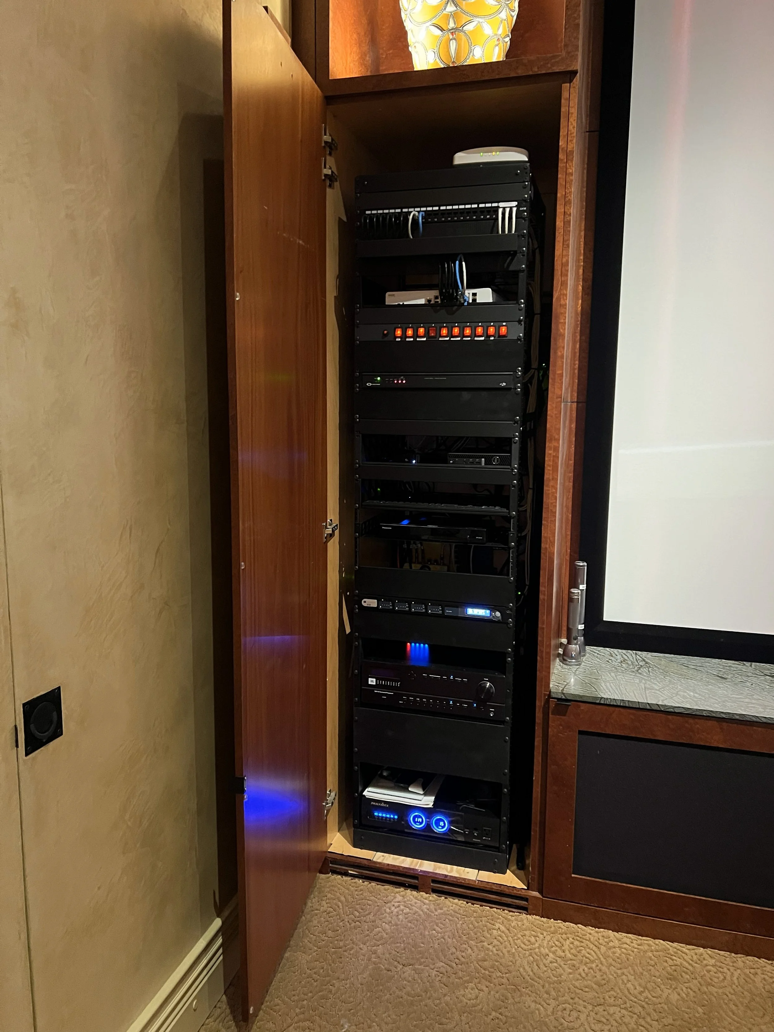 Installed a new server rack filled with electronic equipment for home theater