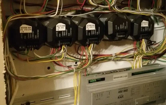 Close-up of electrical relays and wiring inside an electrical panel.
