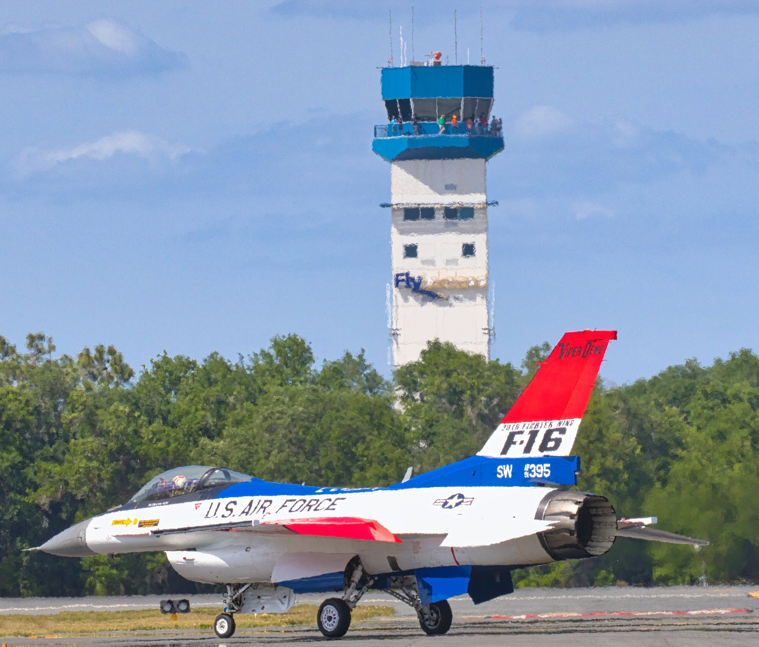 The USAF F-16 Falcon 50 livery driven by "FEMA" of the F-16 Viper Demo Team in from of the Lakeland Linder Regional Airport tower during SUN 'n FUN 2025.