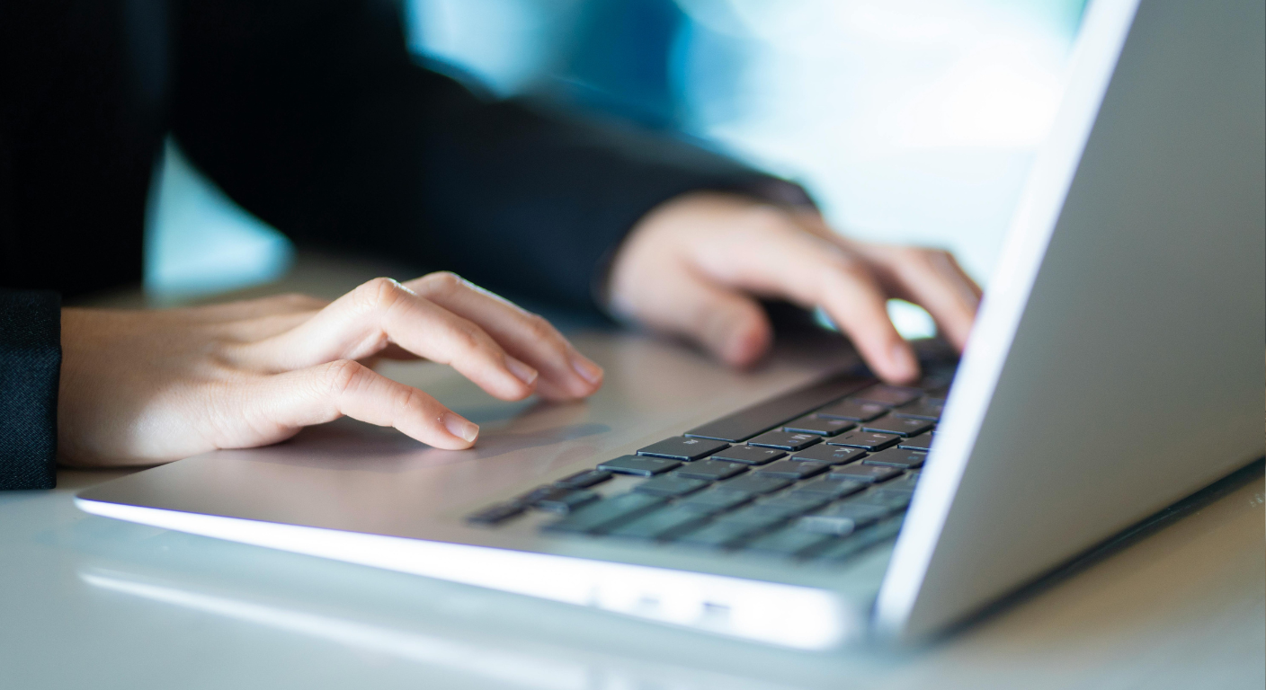 Midwest Title professional working at a computer supporting Michigan commercial title, escrow, and real estate transactions.