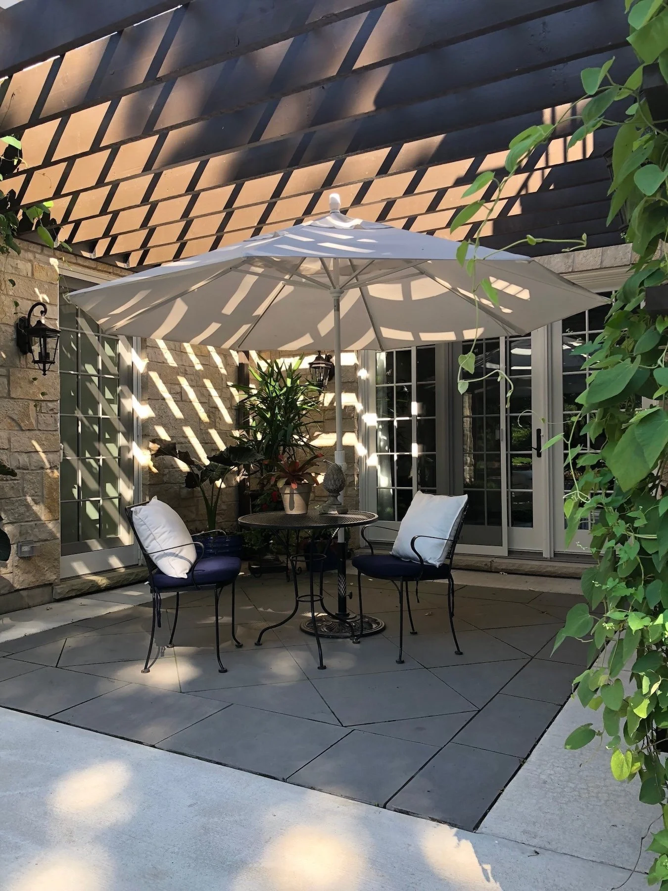 Pergola and stone patio with ivy in Island Lake, IL