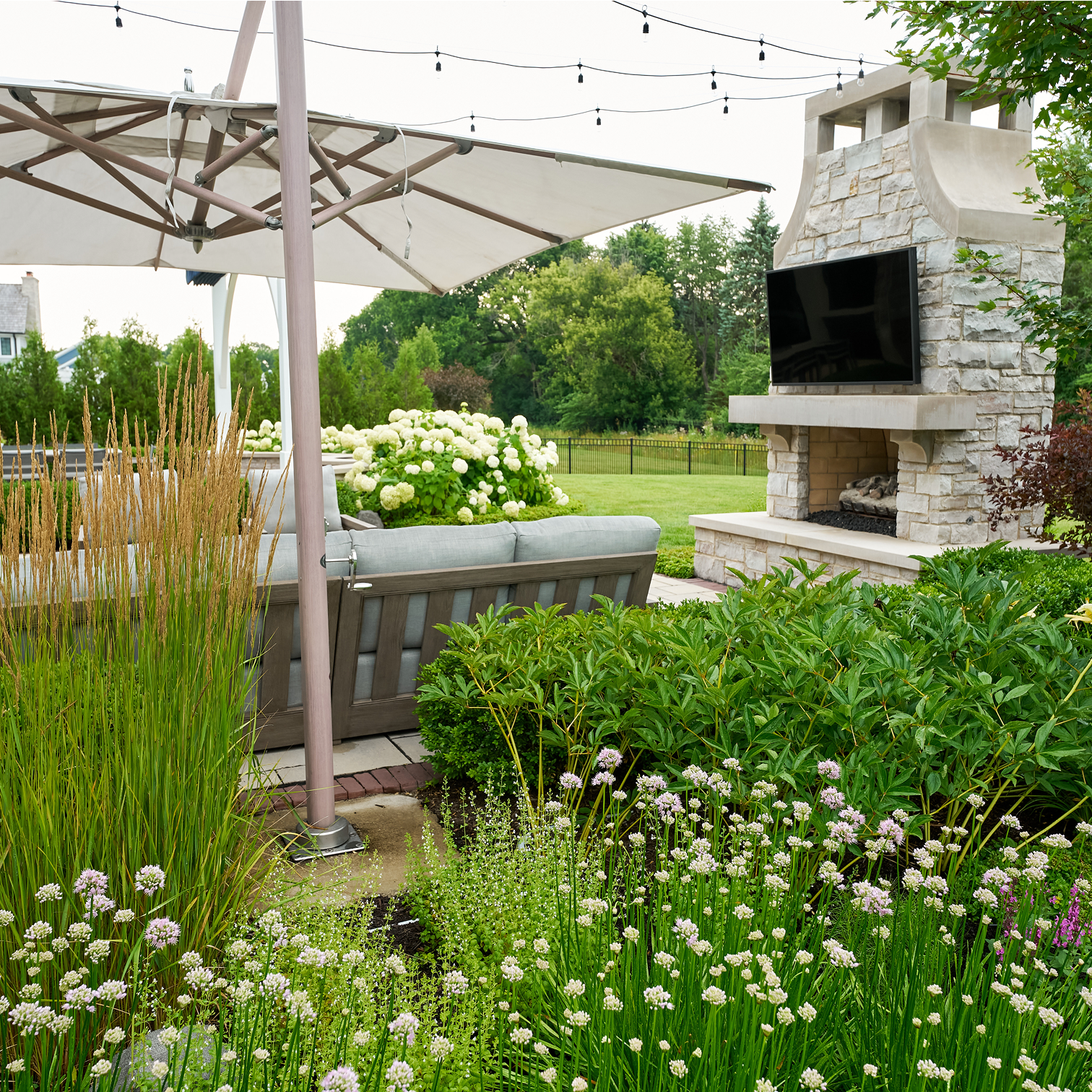 Outdoor Fireplace, Patio, & White Flowers
