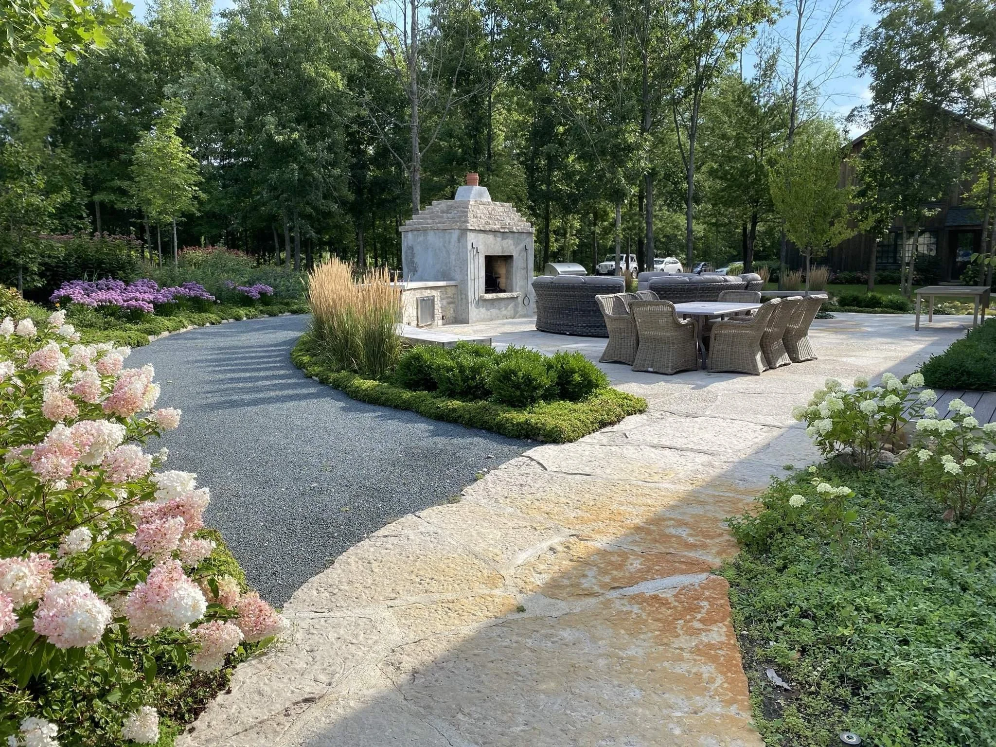 Stone patio, plantings and flowers, outdoor pizza oven