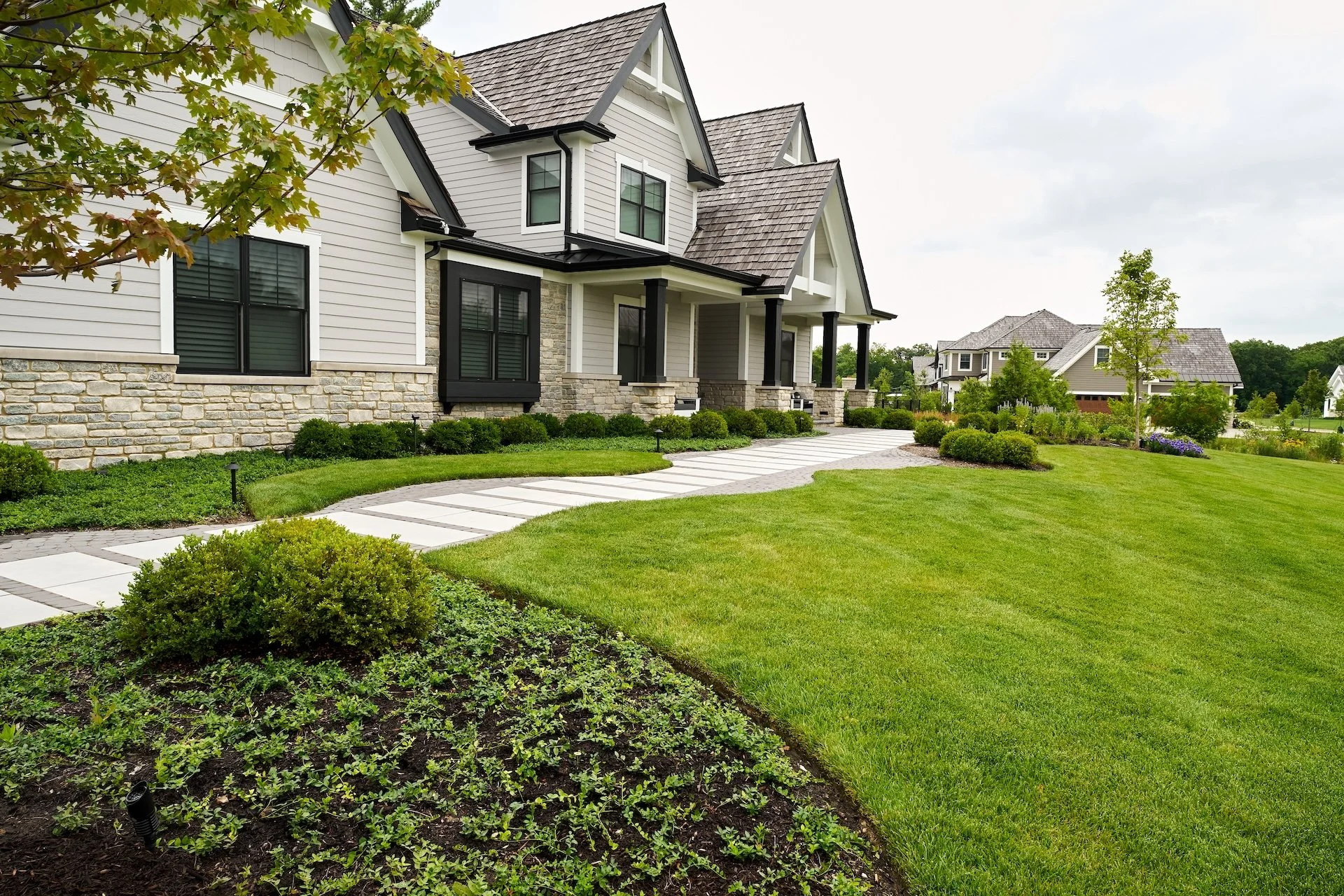 A beautiful green lawn in front of a modern stone home in Wauconda, IL
