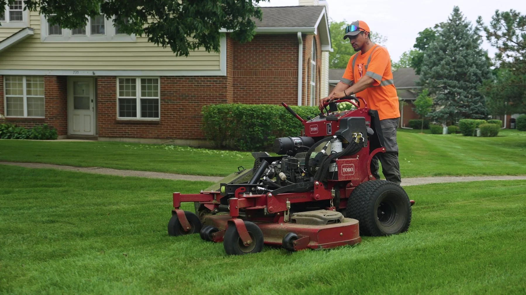 ILT Vignocchi crew member operating a stand on mower