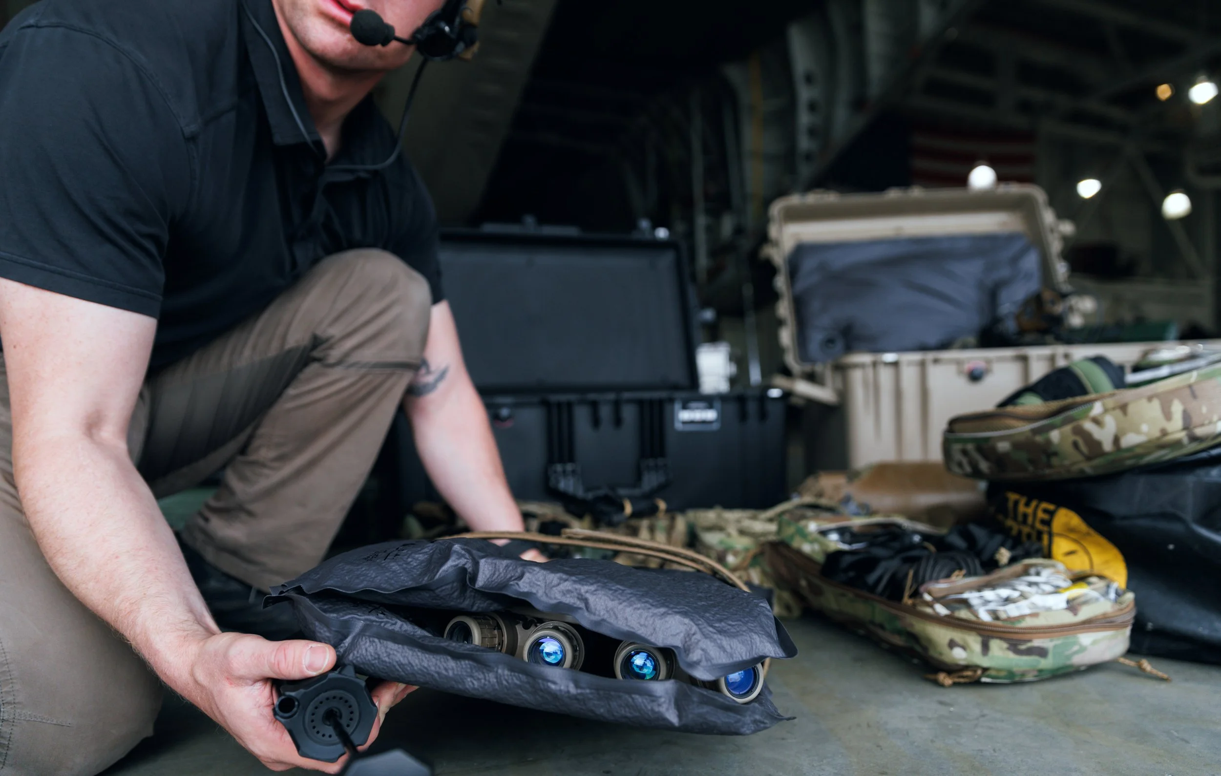 Operator carrying night vision optics protected inside a KOR Vacuum Rigidizing Structure (VRS) panel in a military field environment. KOR VRS | Waterproof Protection for Mission-Critical Equipment