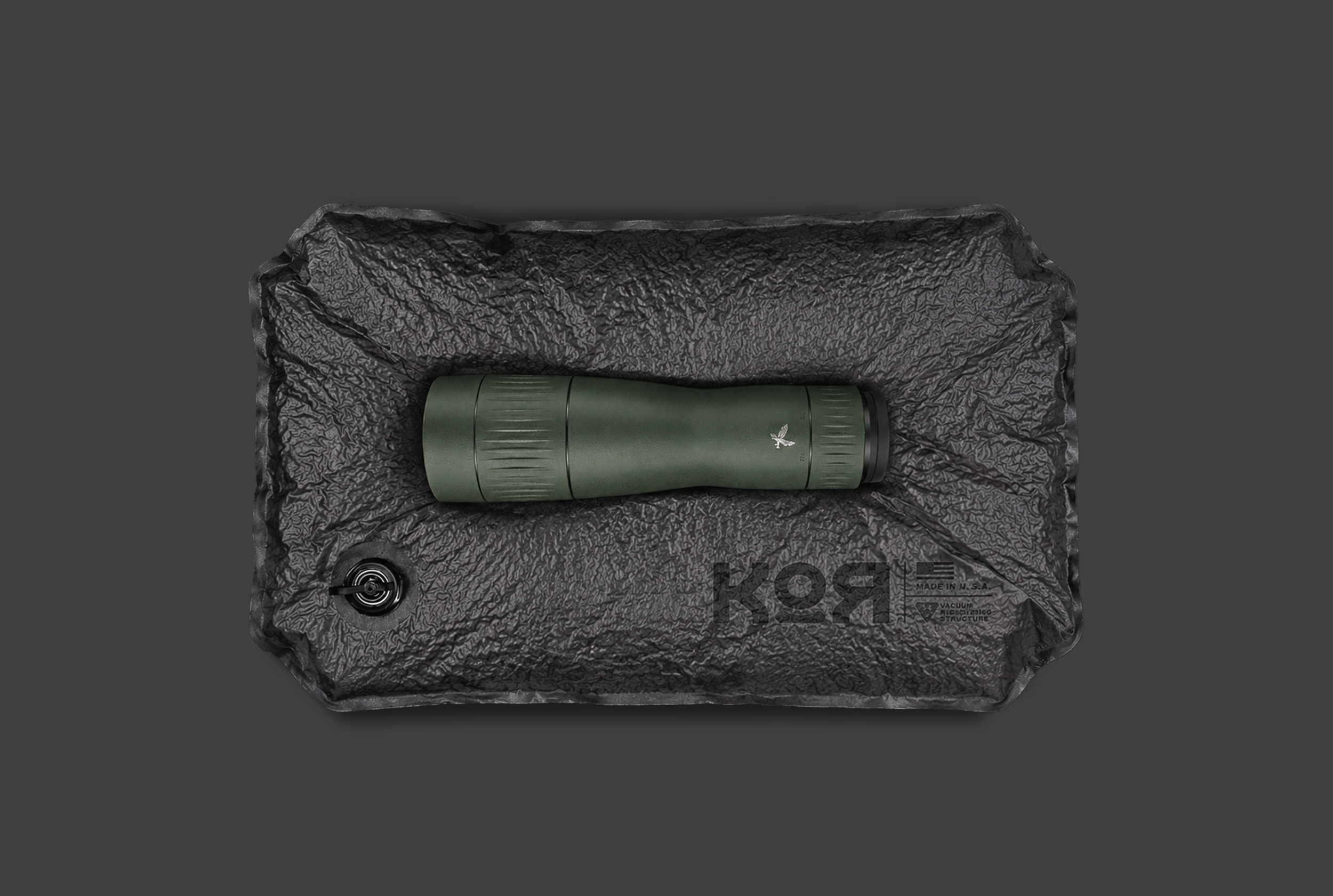 A green Range Finder, Optic.  On a KOR Protection System single panel. In its Solid state On a gray background.