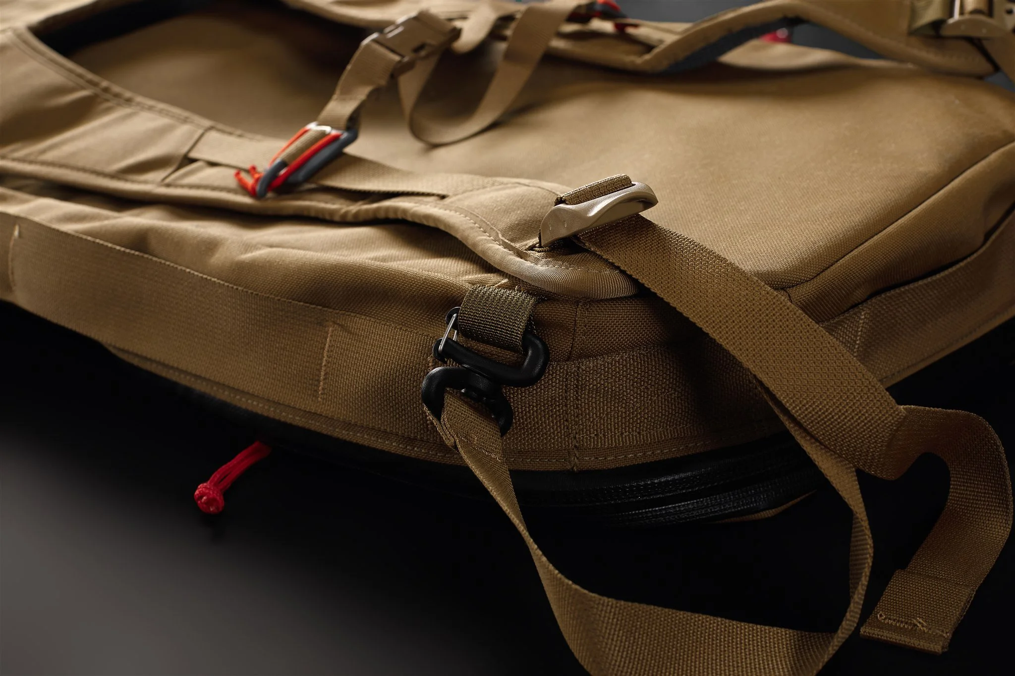 Tan tactical backpack with multiple straps and zipper compartments